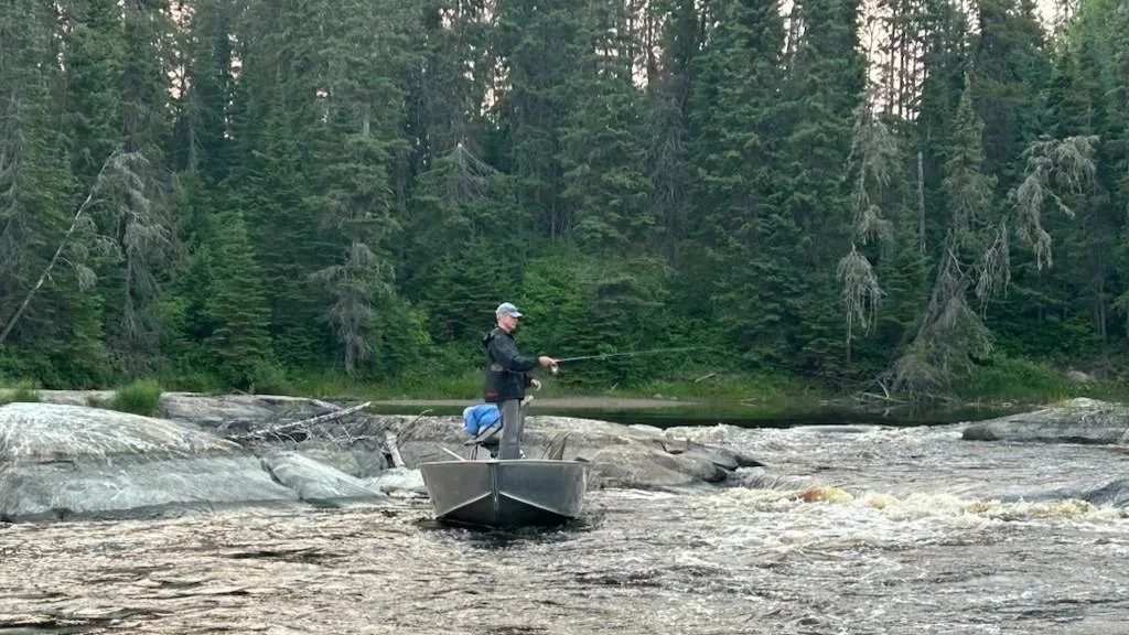 Man Fishing in a Boat