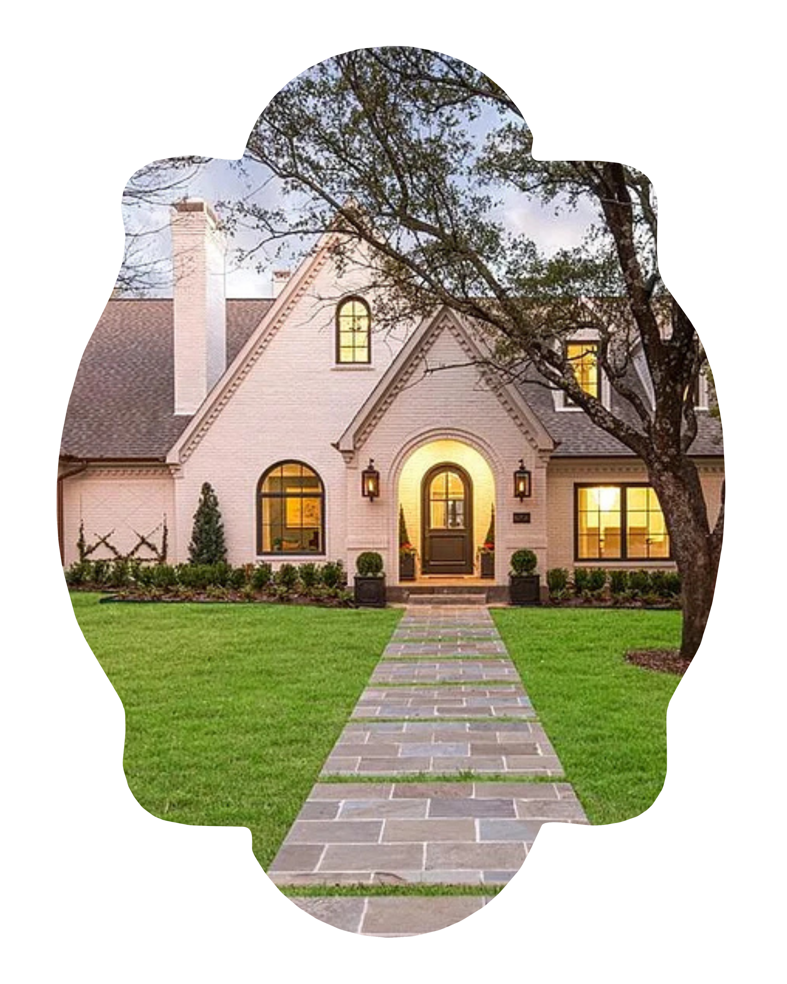 A beautiful house with pink brick walls and black trim, surrounded by a green lawn, trees, and a stone walkway leading to the front door.