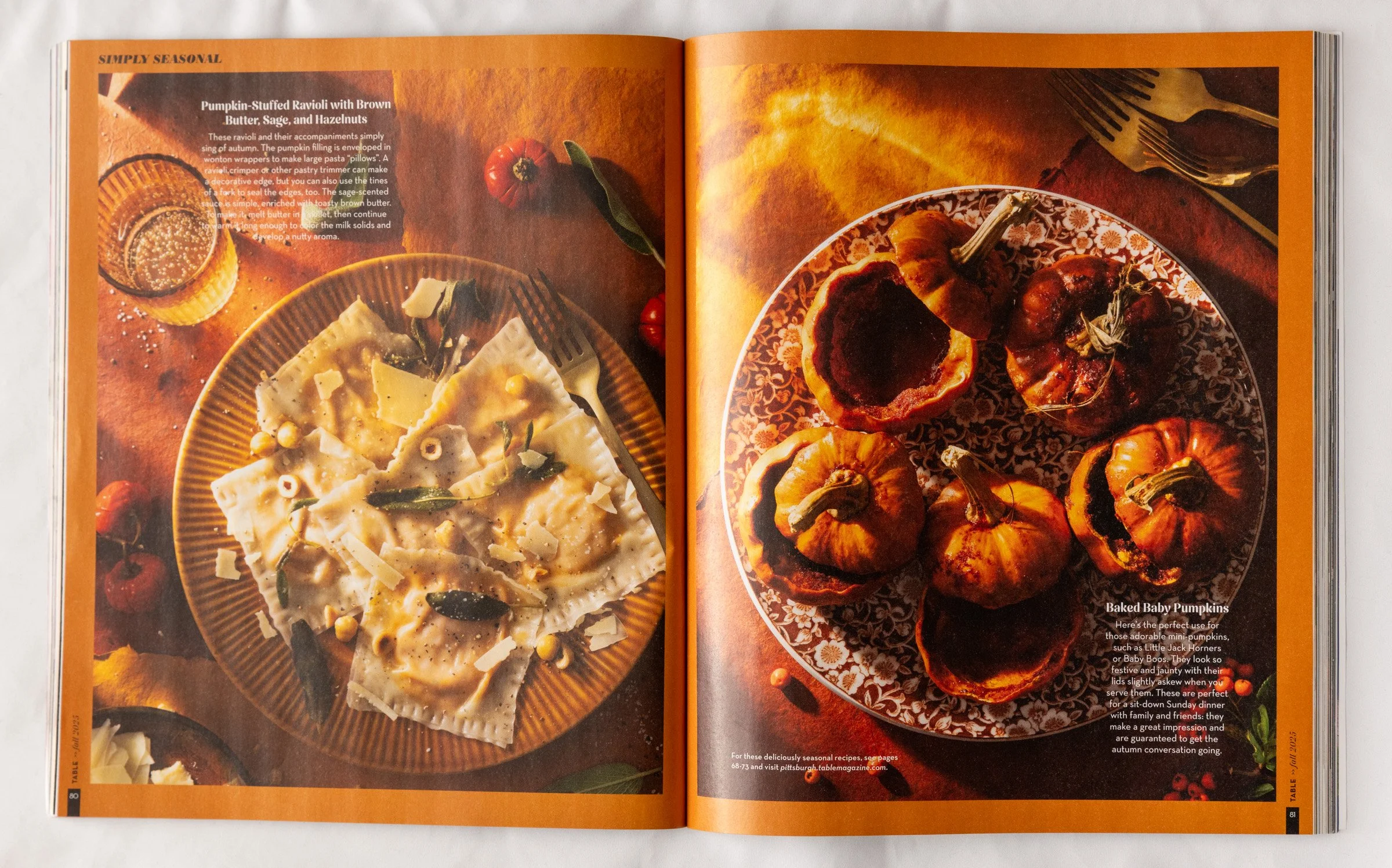 Two plates of fall-themed food: on the left, pumpkin-stuffed ravioli with brown butter, sage, and hazelnuts on a yellow plate, and on the right, baked baby pumpkins on a decorative plate. The background includes small pumpkins and autumn leaves.