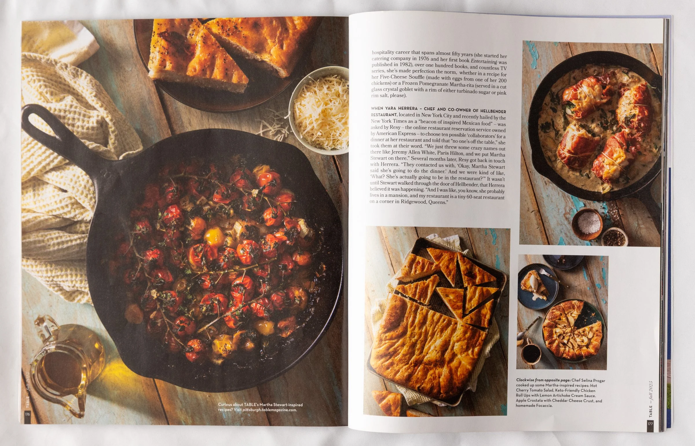 Open magazine spread featuring images of homemade dishes including a cherry tomato pan, a baked dish with chicken, a tray of sliced baked crust, and a pie on a rustic wooden table.