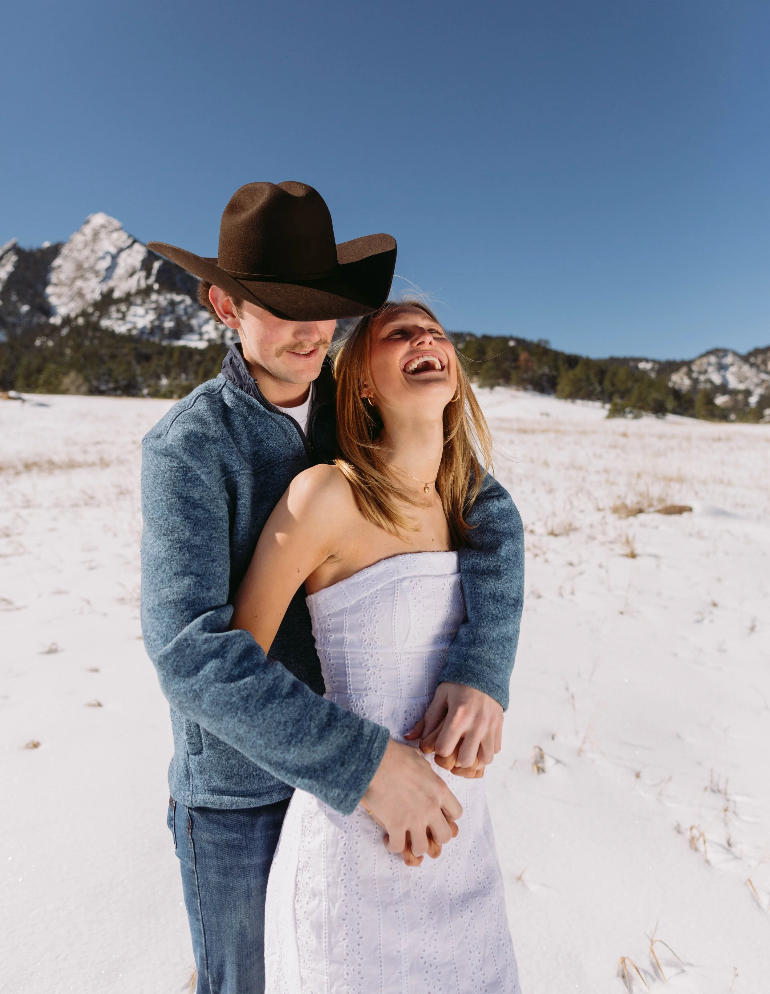 Couple senior portrait in winter setting celebrating graduation in Boulder Colorado
