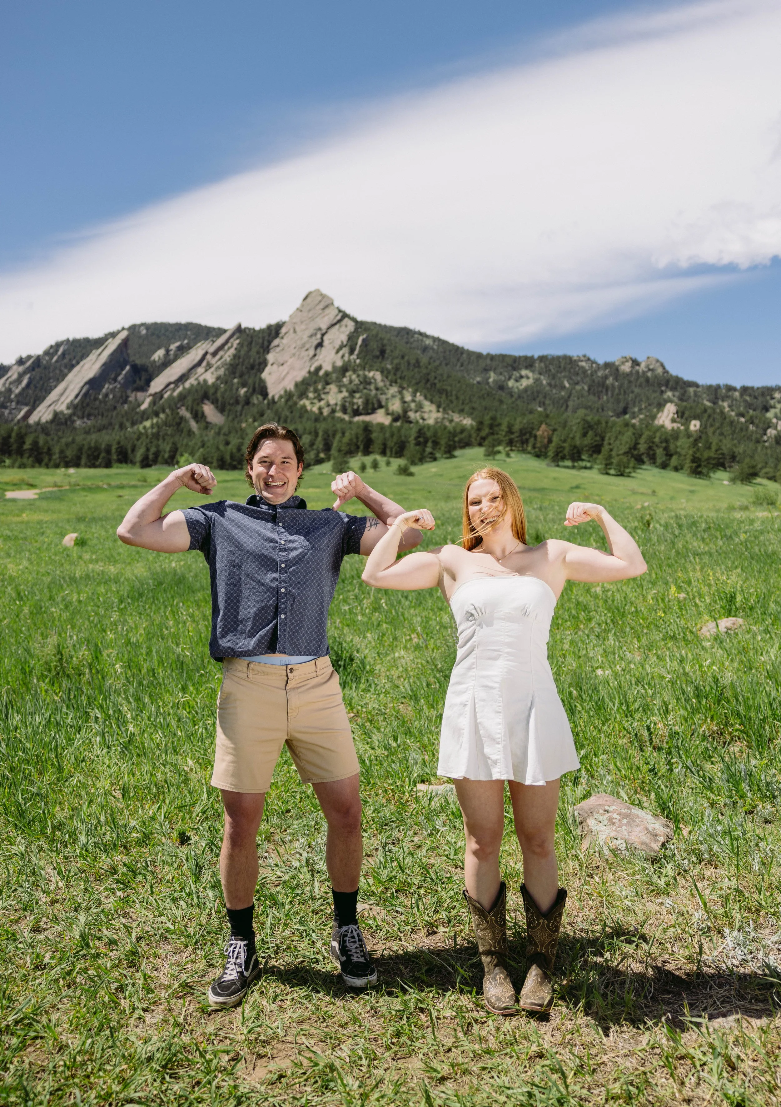 CU Boulder senior couple celebrating graduation in open field at Chautauqua Park