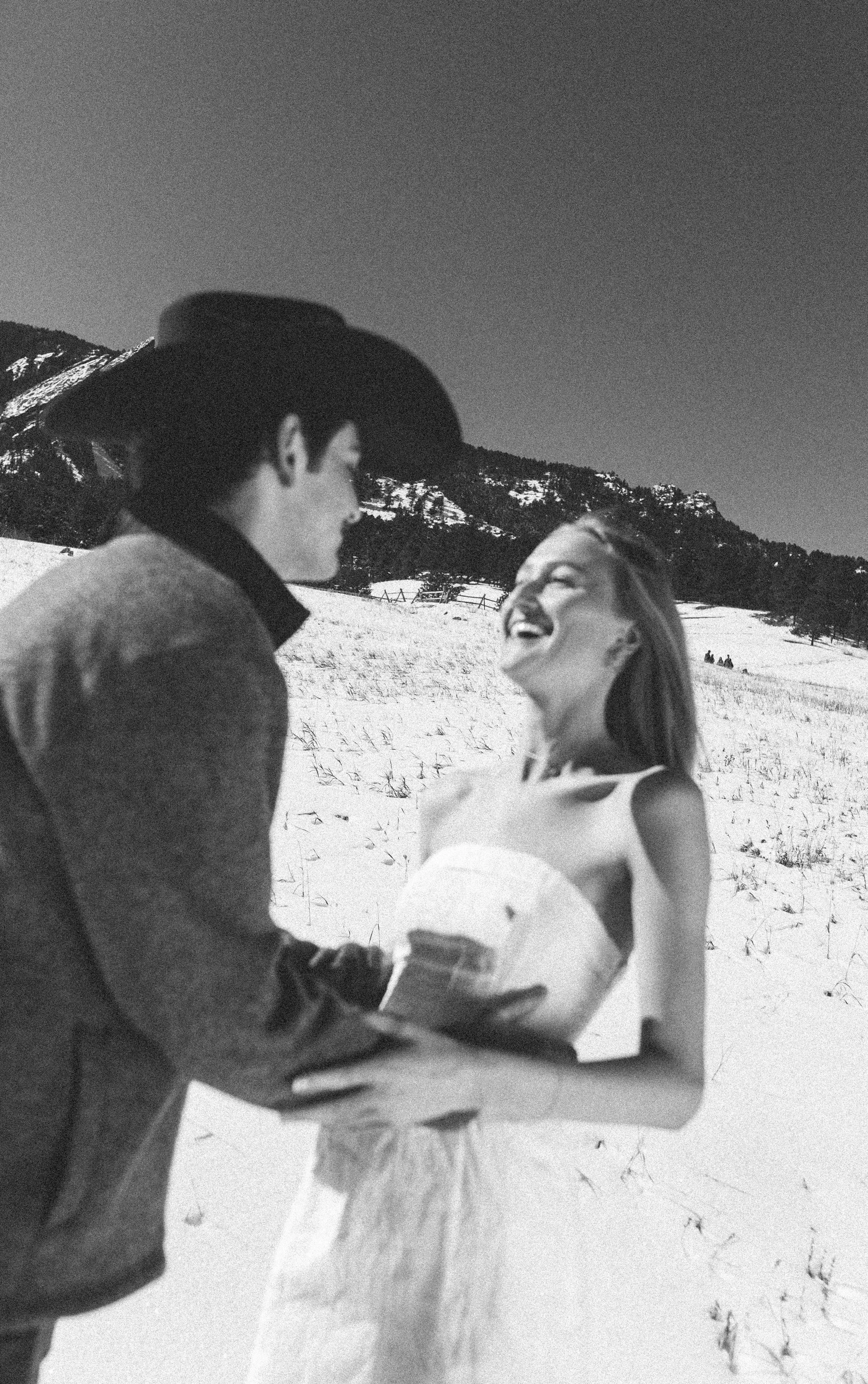 CU Boulder graduation photo of a senior celebrating with champagne at Chautauqua Park, with the Flatirons as the iconic Boulder backdrop.