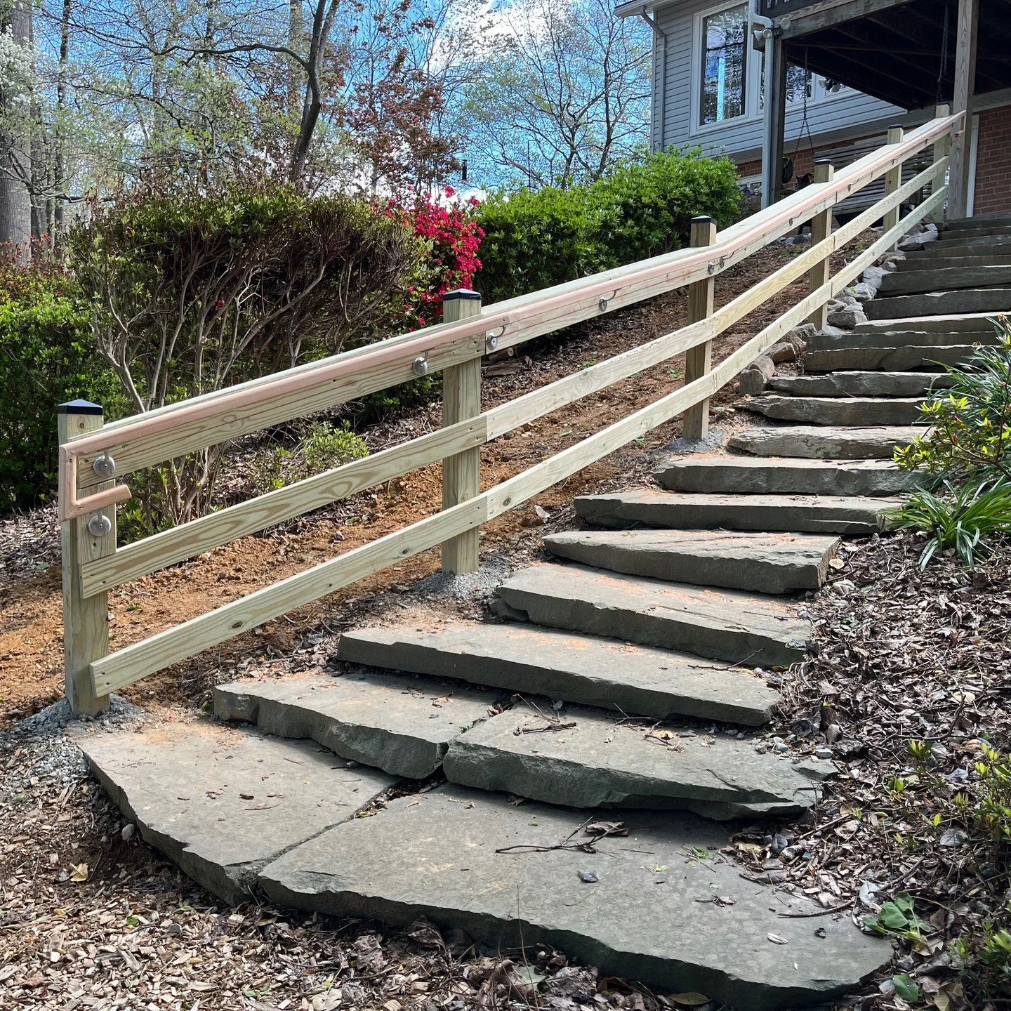 This existing stone staircase needed a handrail for the elderly couple that wanted to continue accessing their backyard trail! We installed a contour matching banister with a grippy cedar handrail!
