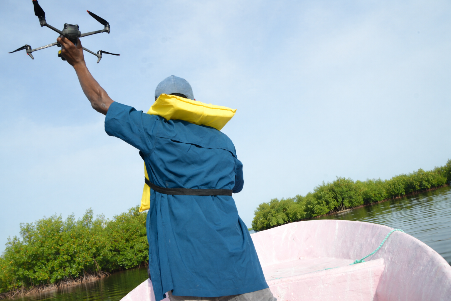 man holding a drone in the field