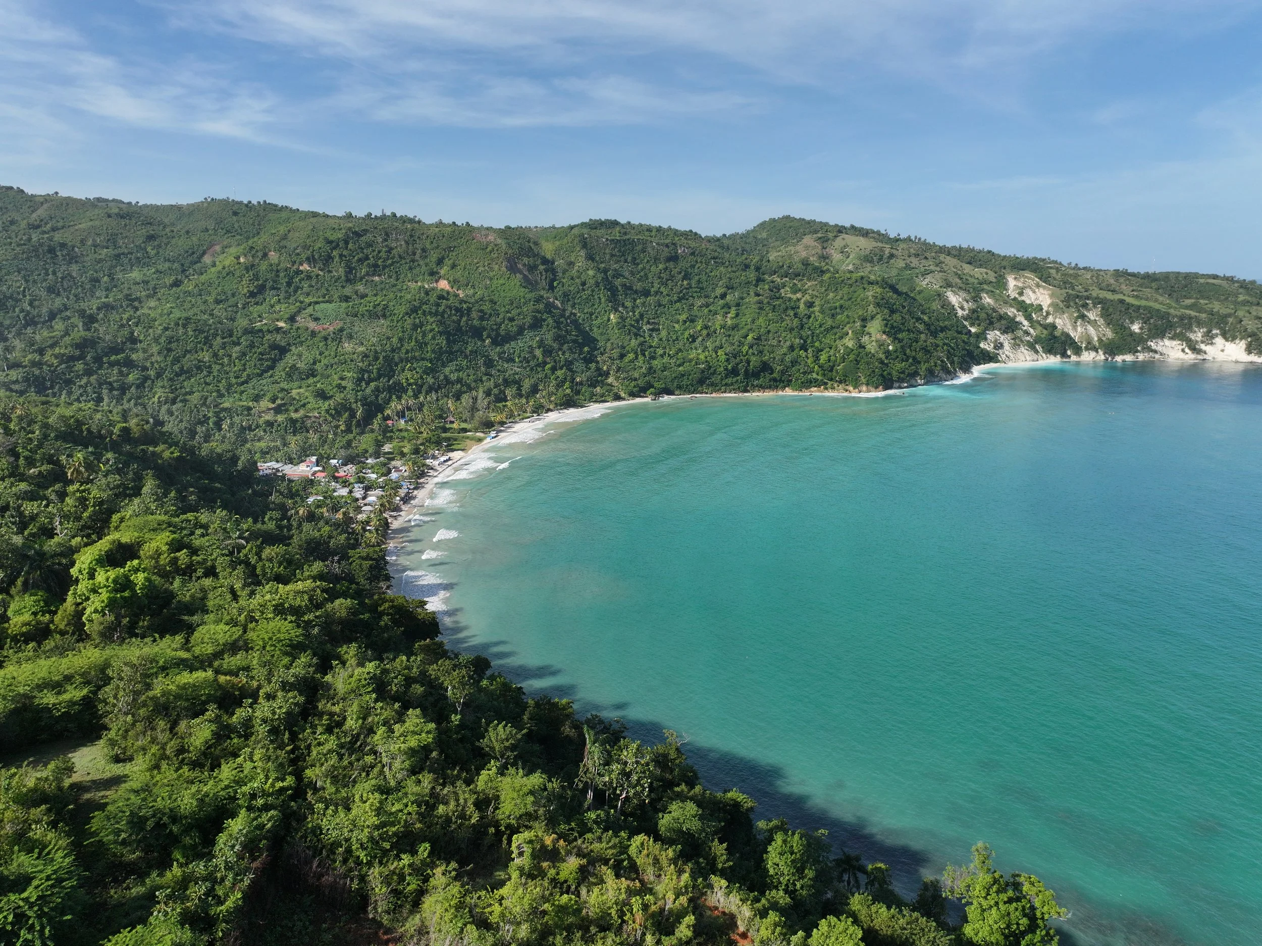 a coastal community with blue beach and a number of homes near the coast