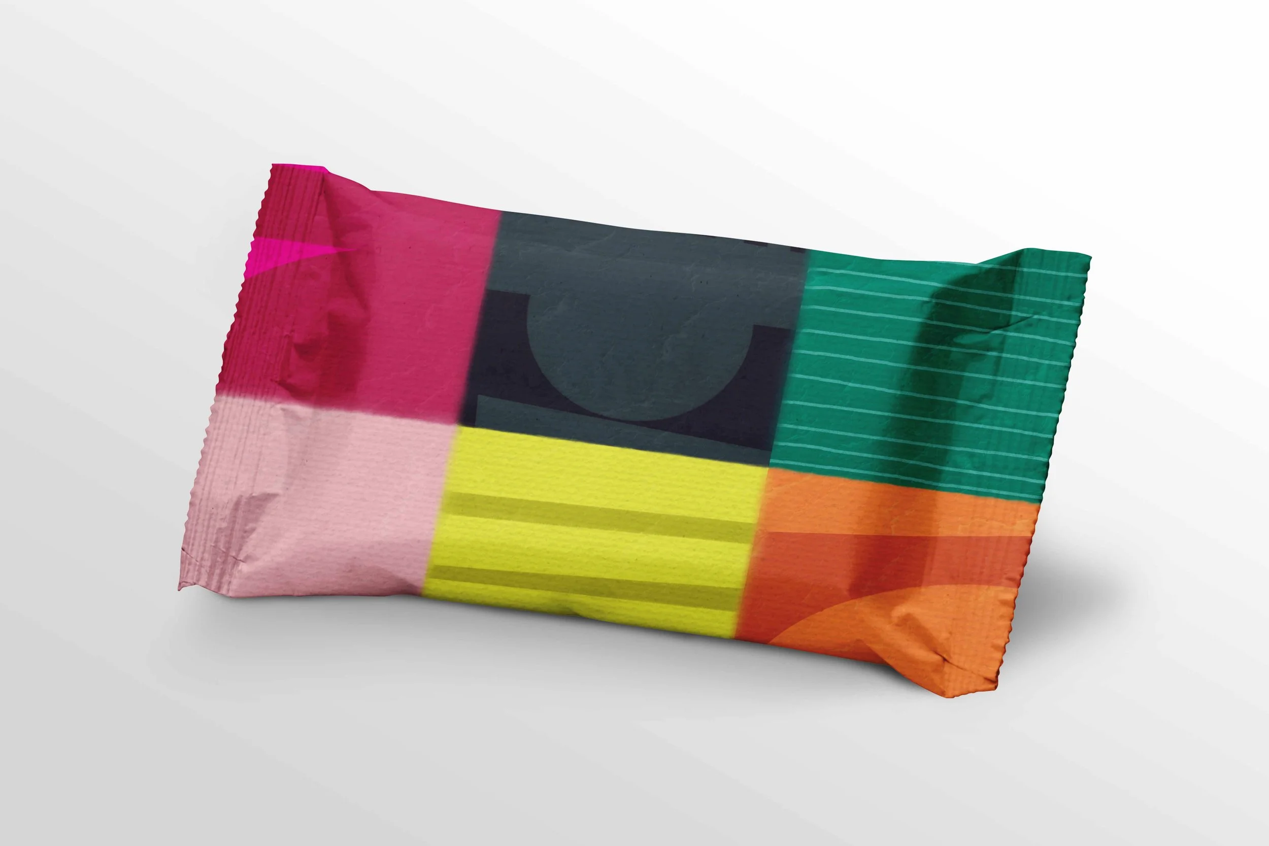 Colorful candy wrapper with a patchwork design of pink, black, green, yellow, orange, and red sections.