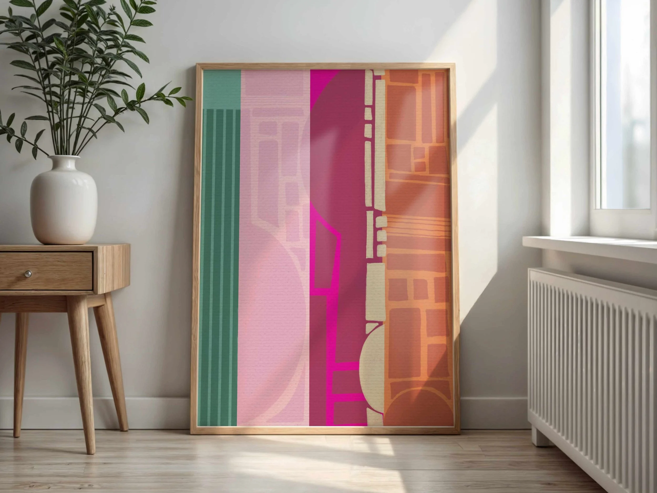 Interior scene of a room with a potted plant on a small wooden table, a colorful abstract artwork leaning against the wall, a window with sunlight streaming in, and a radiator below the window.