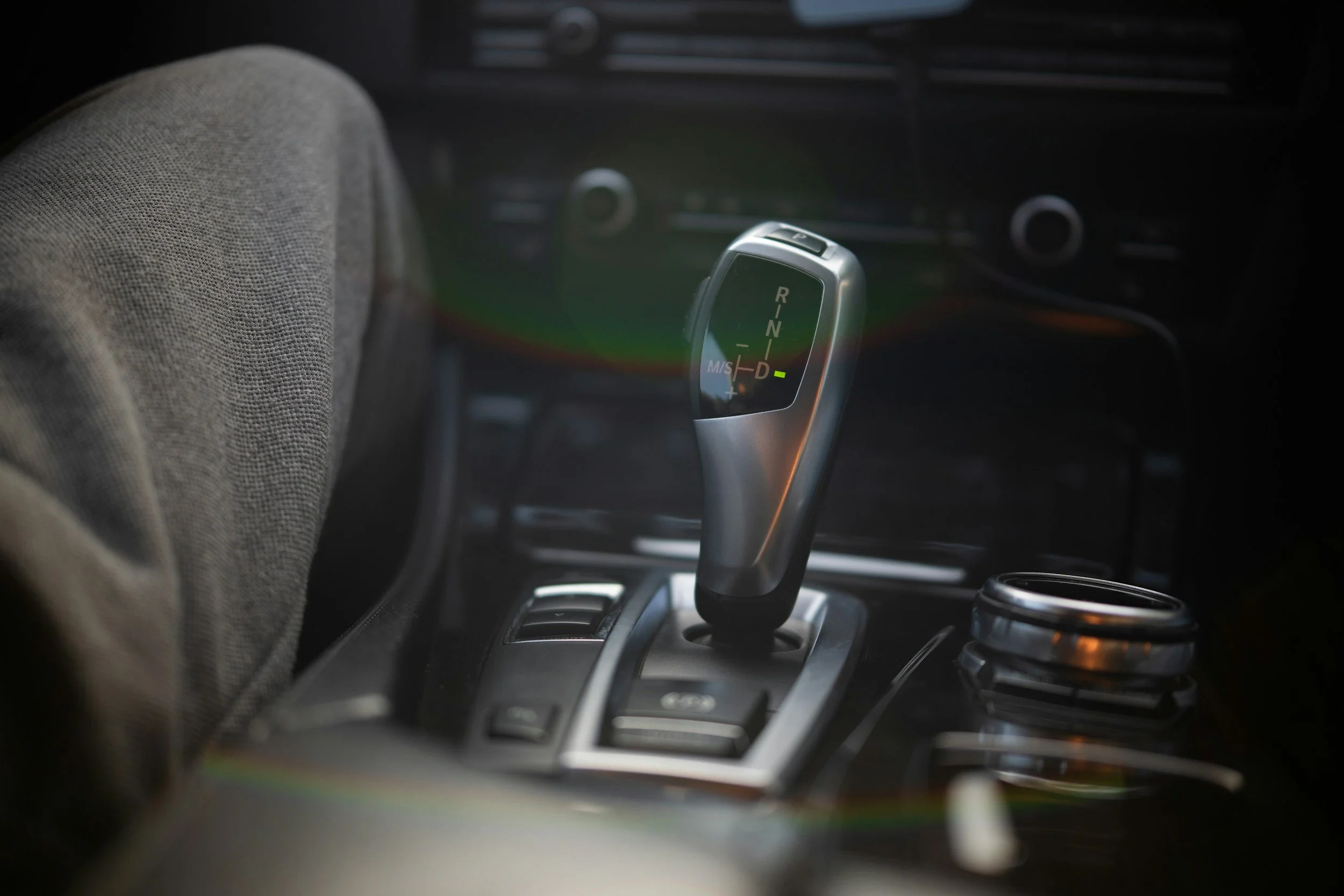 Close-up of a modern automatic car gear shifter in a vehicle interior.