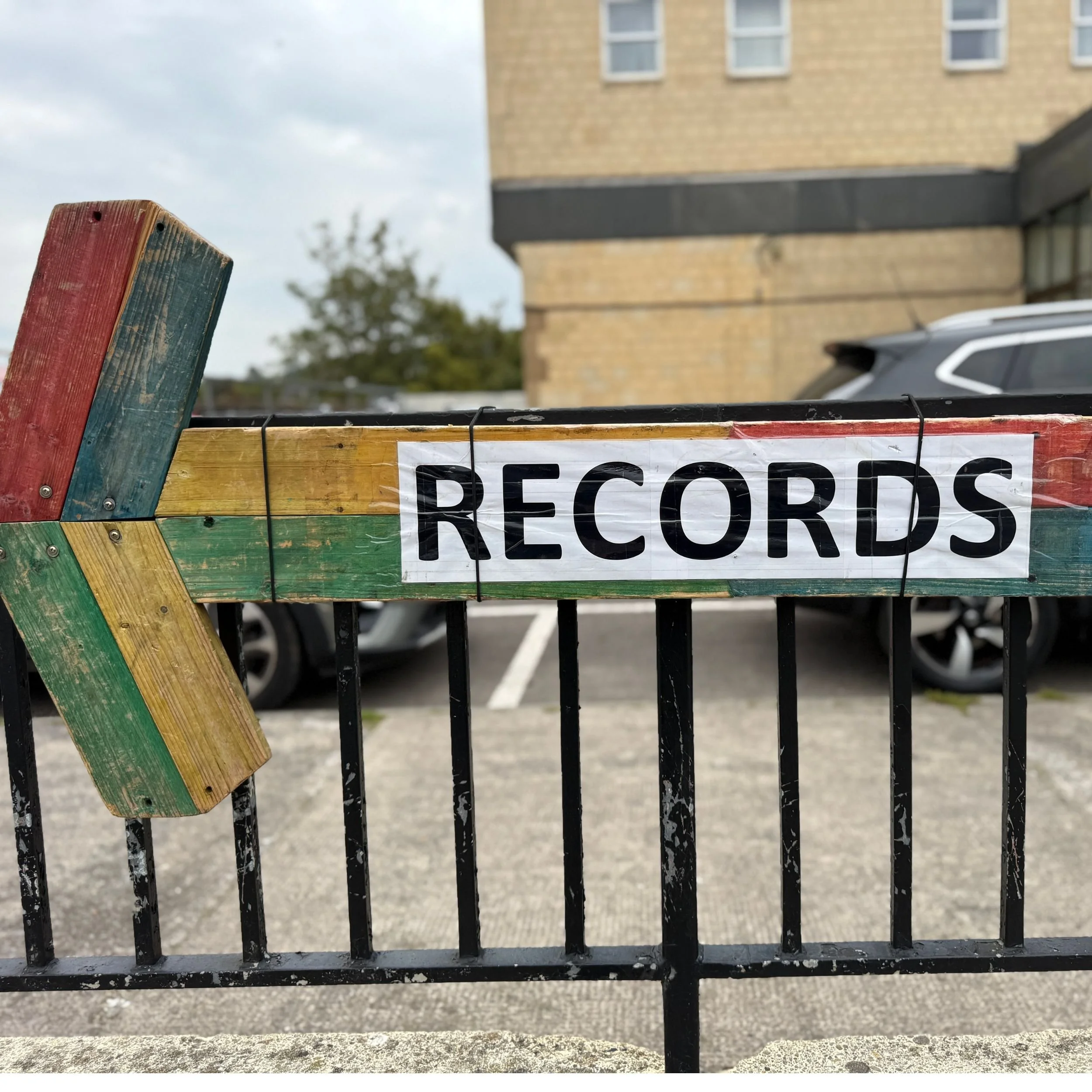 A hand painted arrow points to record stalls at Bath Market