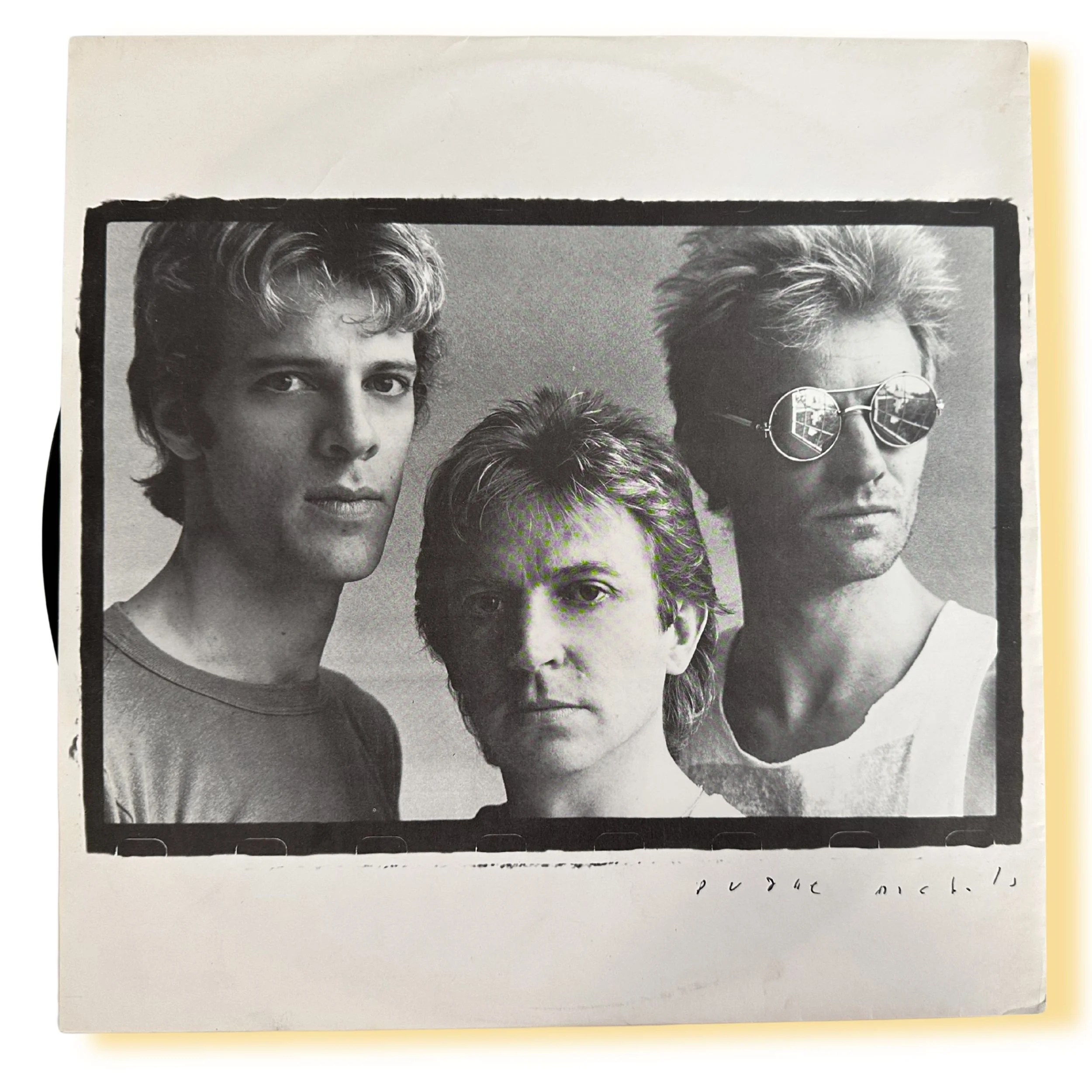 Black-and-white inner sleeve band photo of The Police from Synchronicity, showing Sting, Stewart Copeland, and Andy Summers in a tightly framed studio portrait.