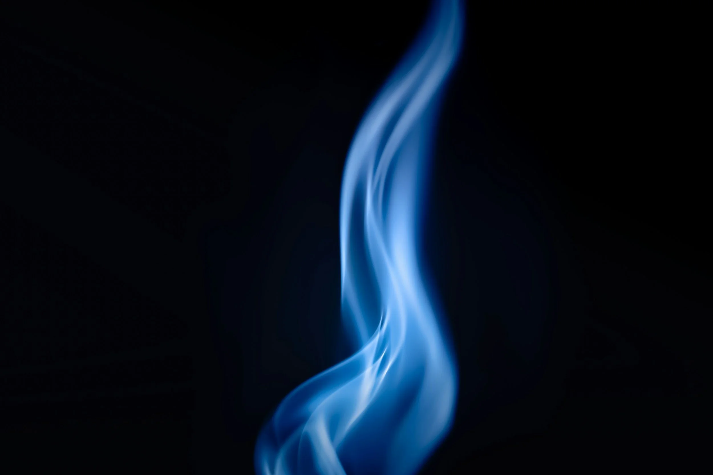 Blue smoke tendrils swirling against a black background.