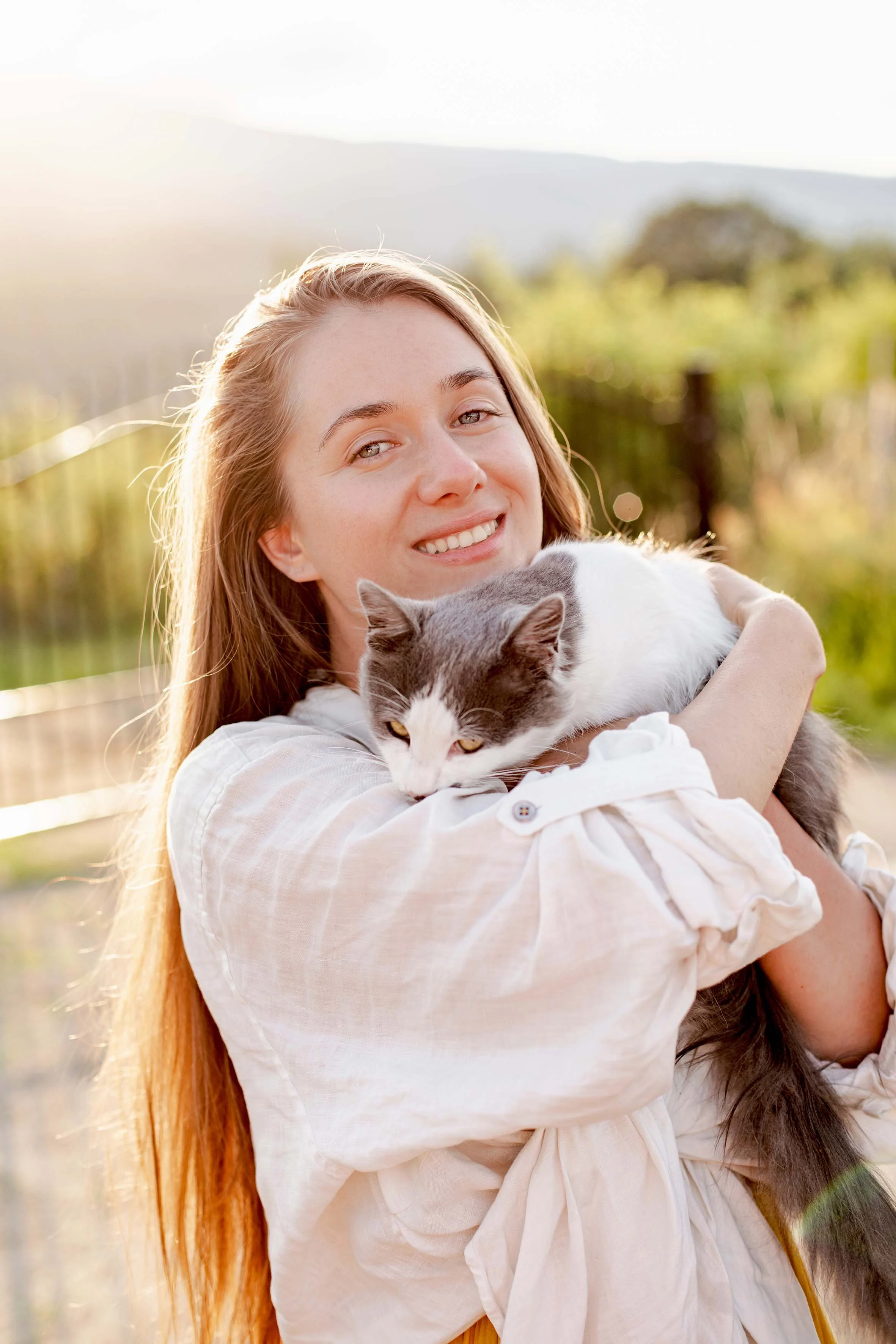 portrait of a cat and a girl with blue eyes