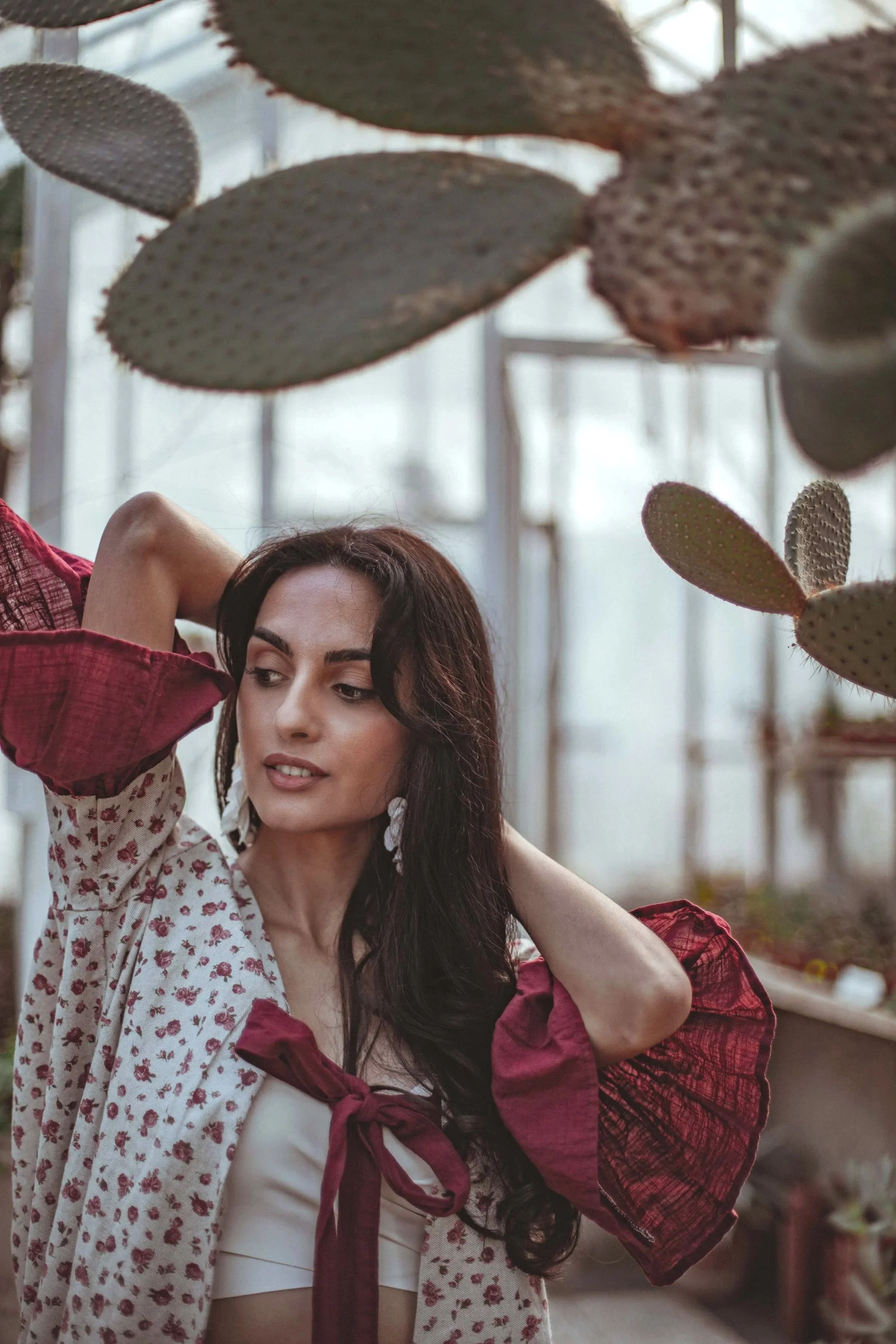 beautiful girl in red posing in the botanical garden