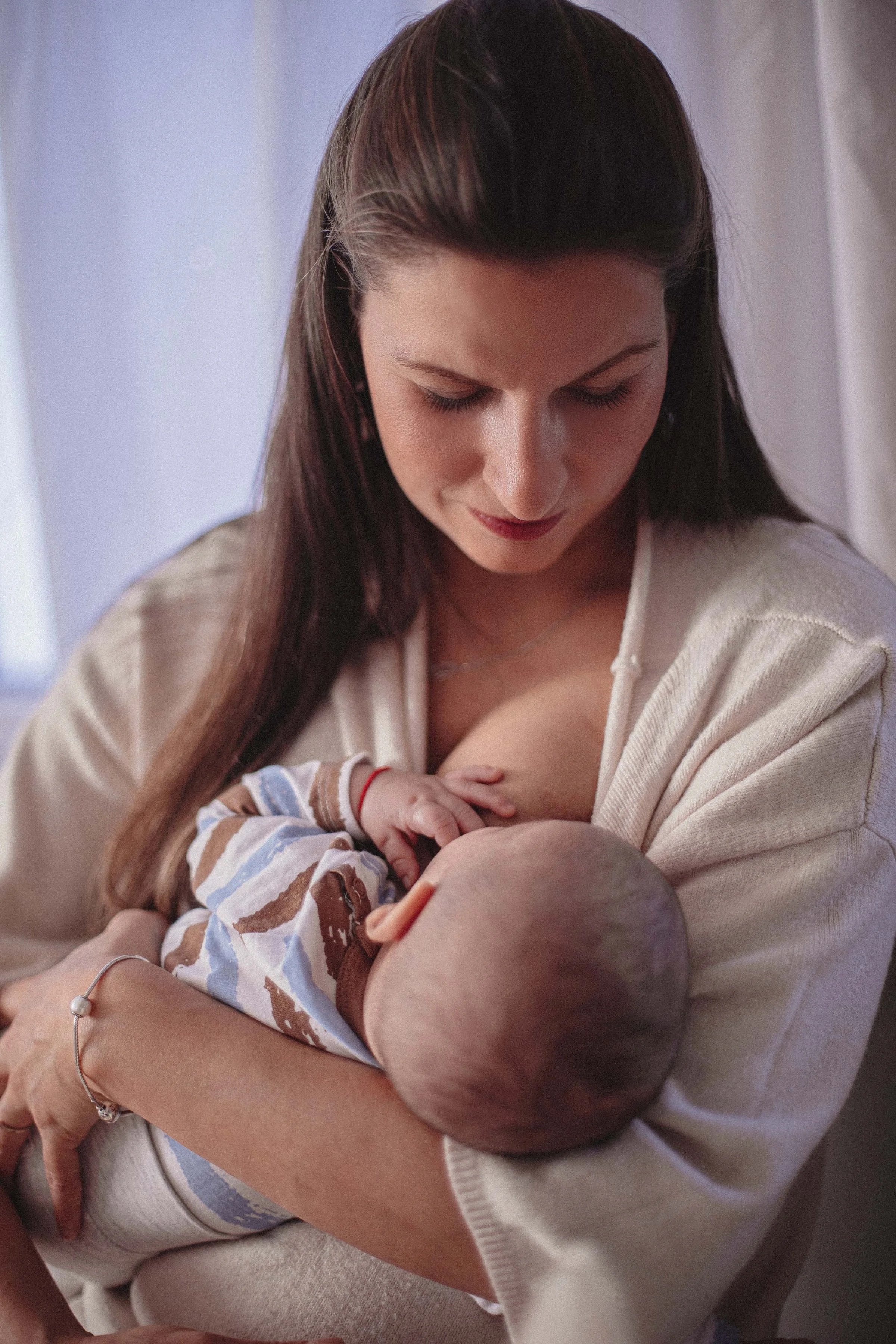 mother breastfeeding her child gentle photoshoot