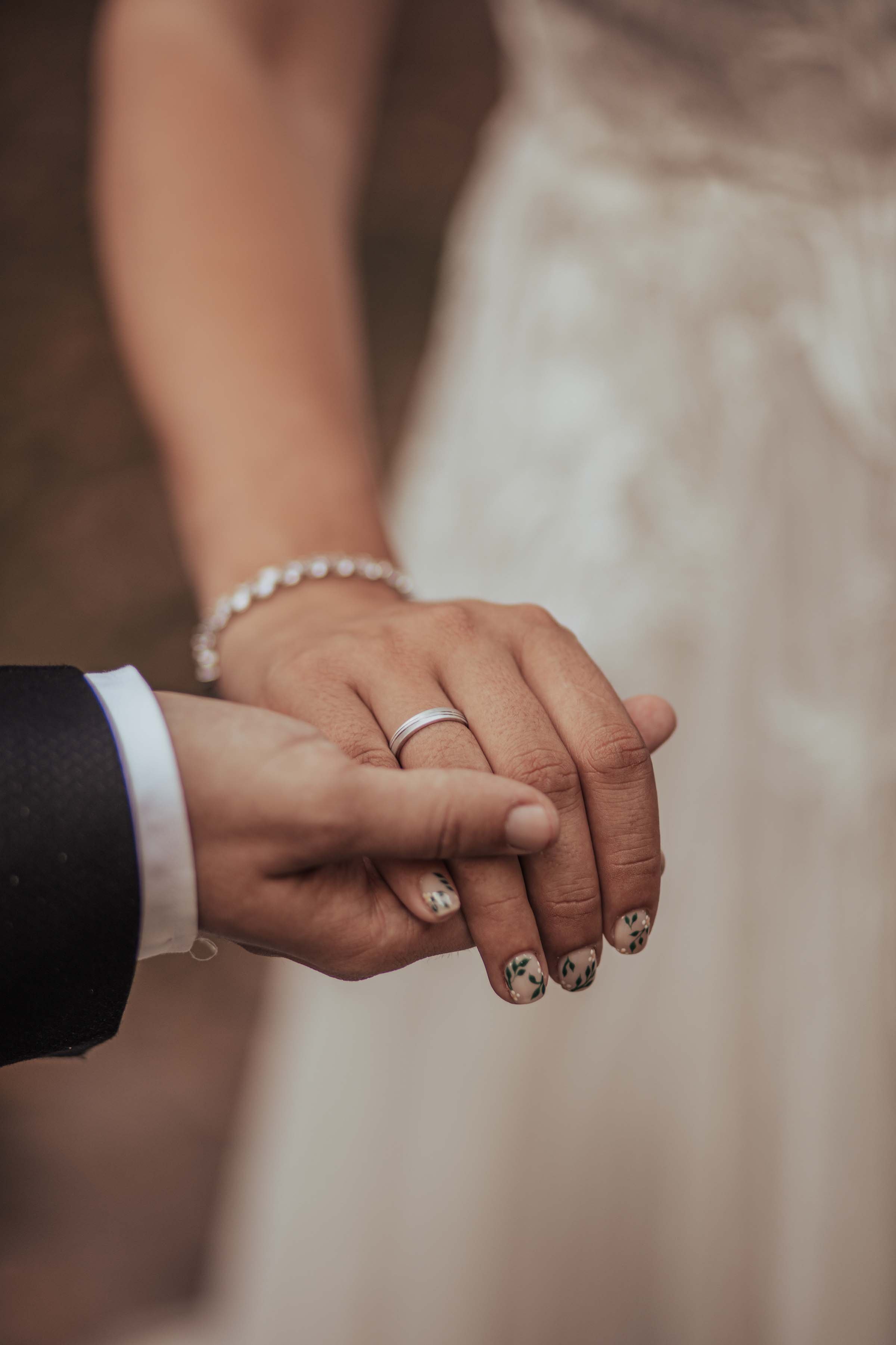 detail of two hands holding professional wedding photoshoot
