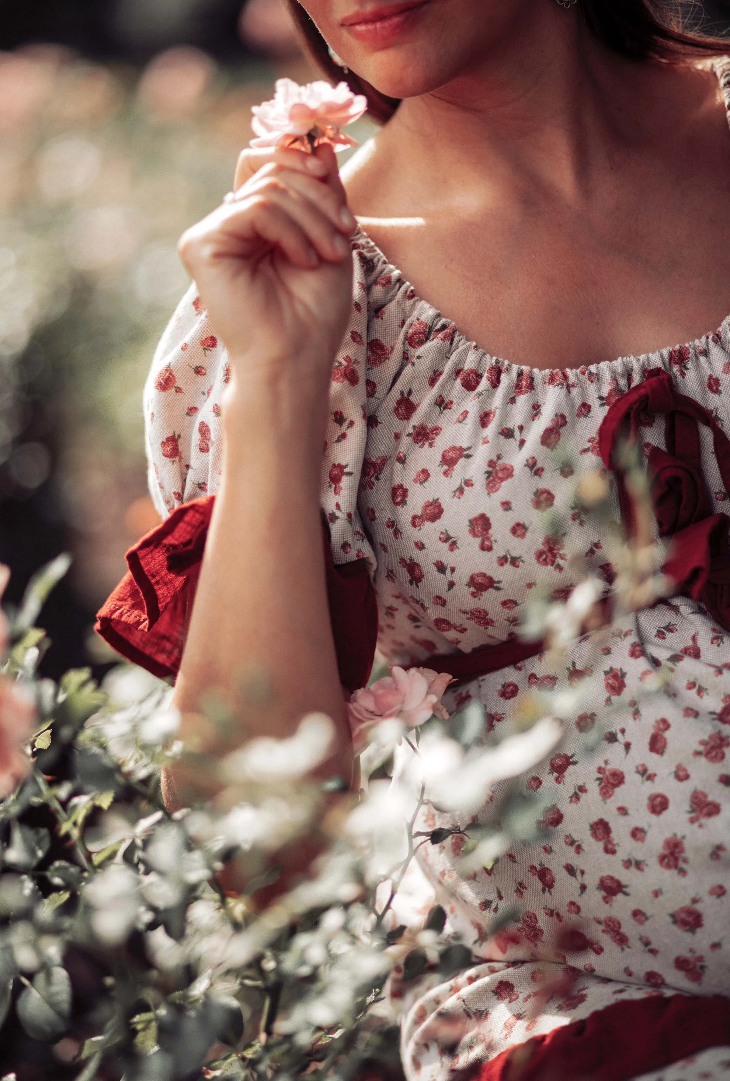details photography a woman with flower dress smells the flowers