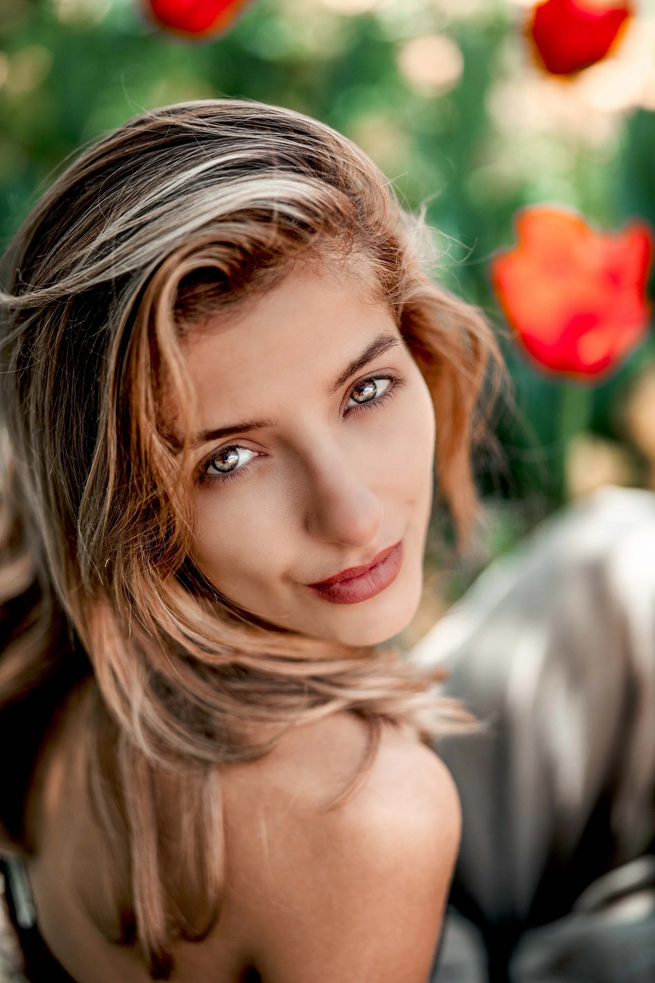 gentle woman portrait on a field of red tulips