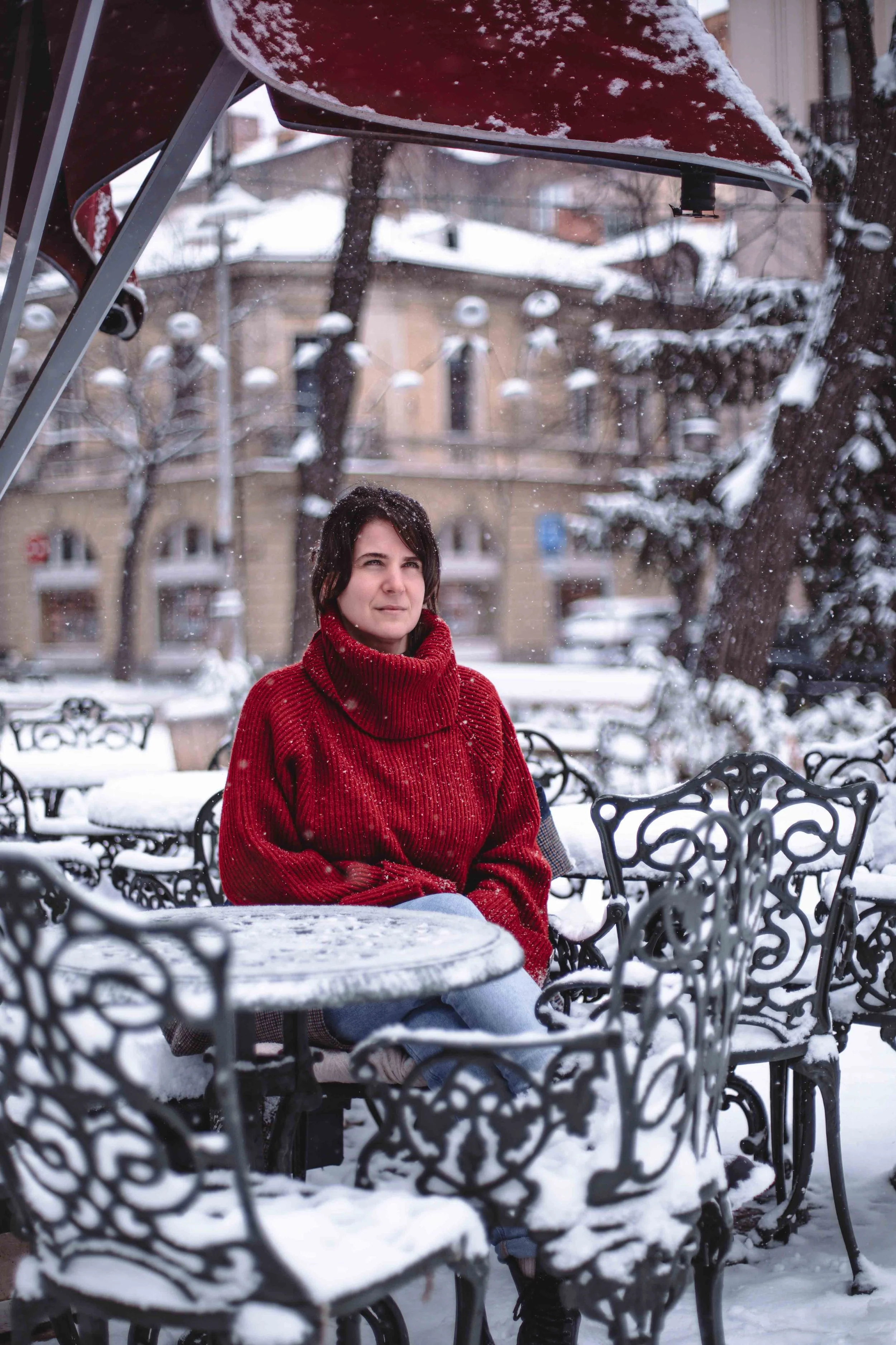 woman in red in a French cafe during winter