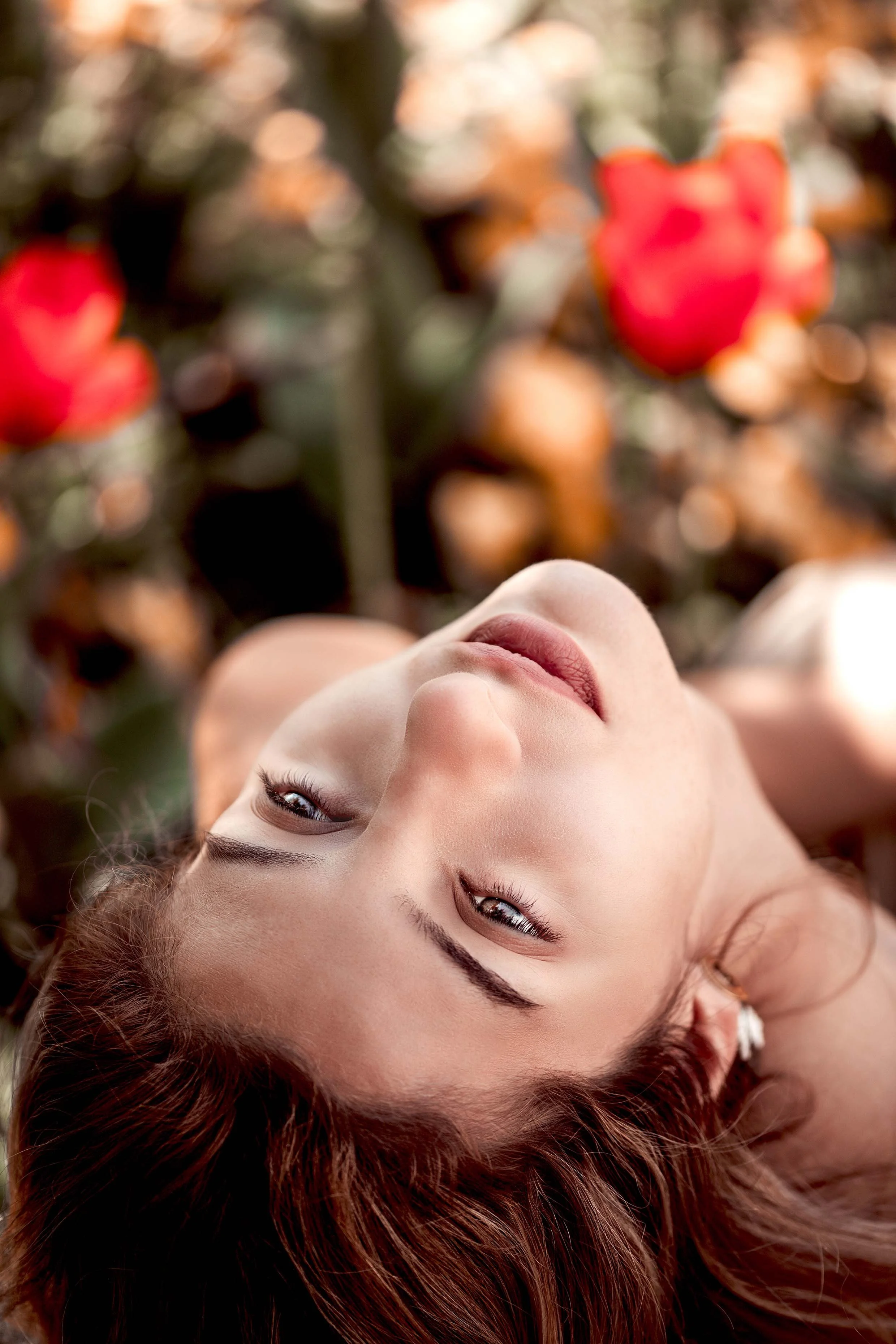 gentle woman portrait on a field of red tulips