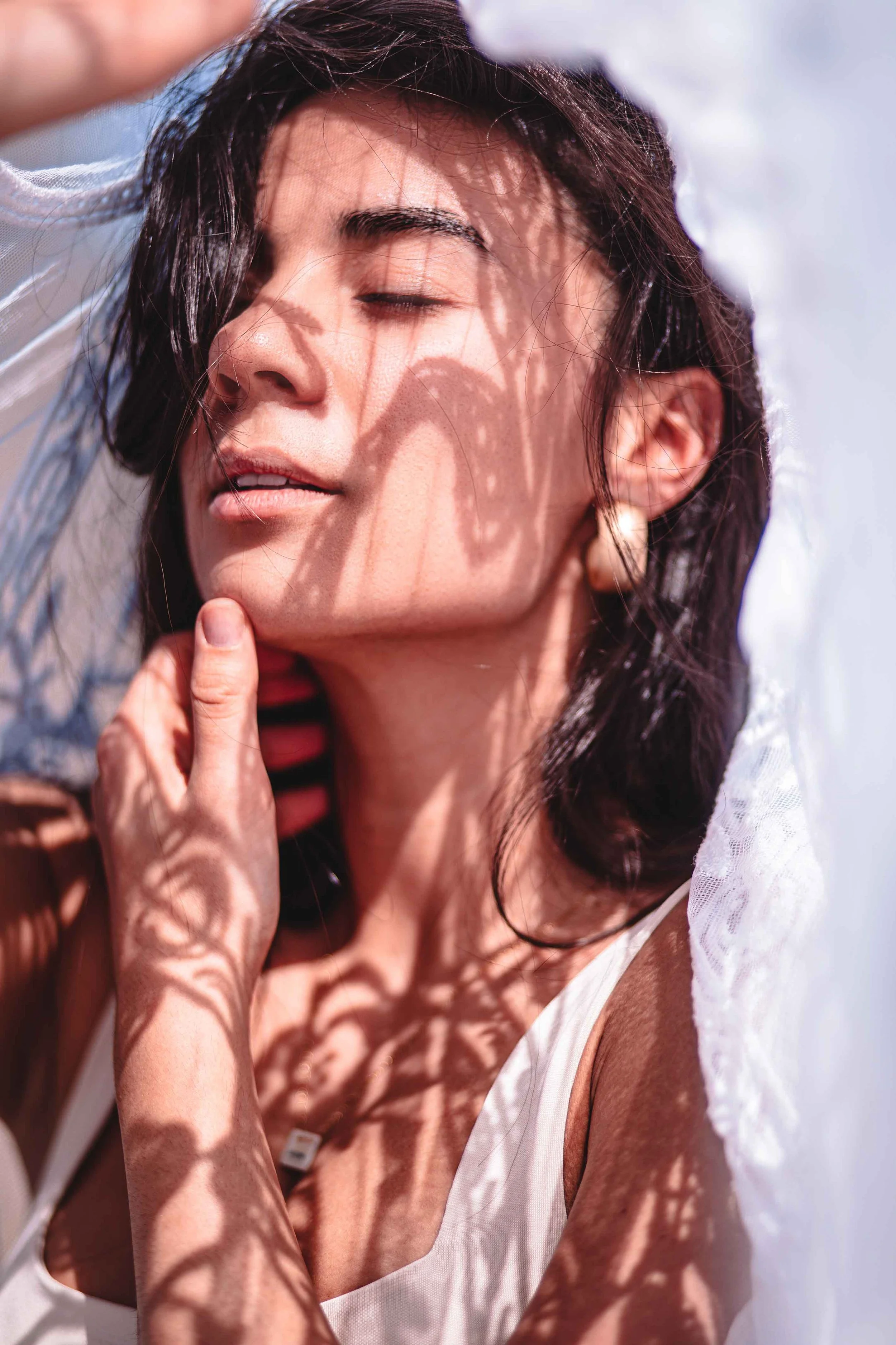 aesthetic photography with a woman with white scarf in the sun