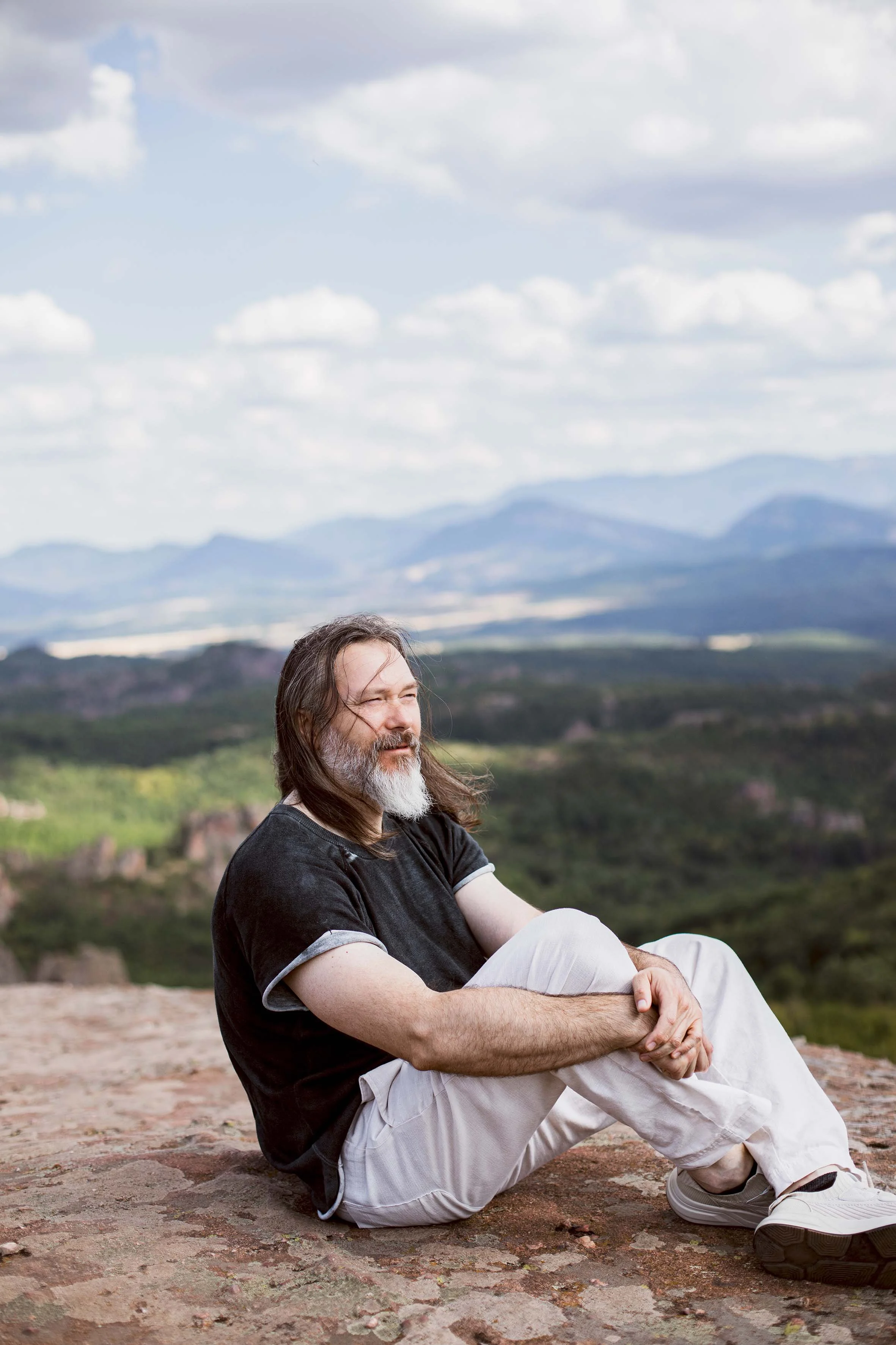 beautiful man standing on top of the world