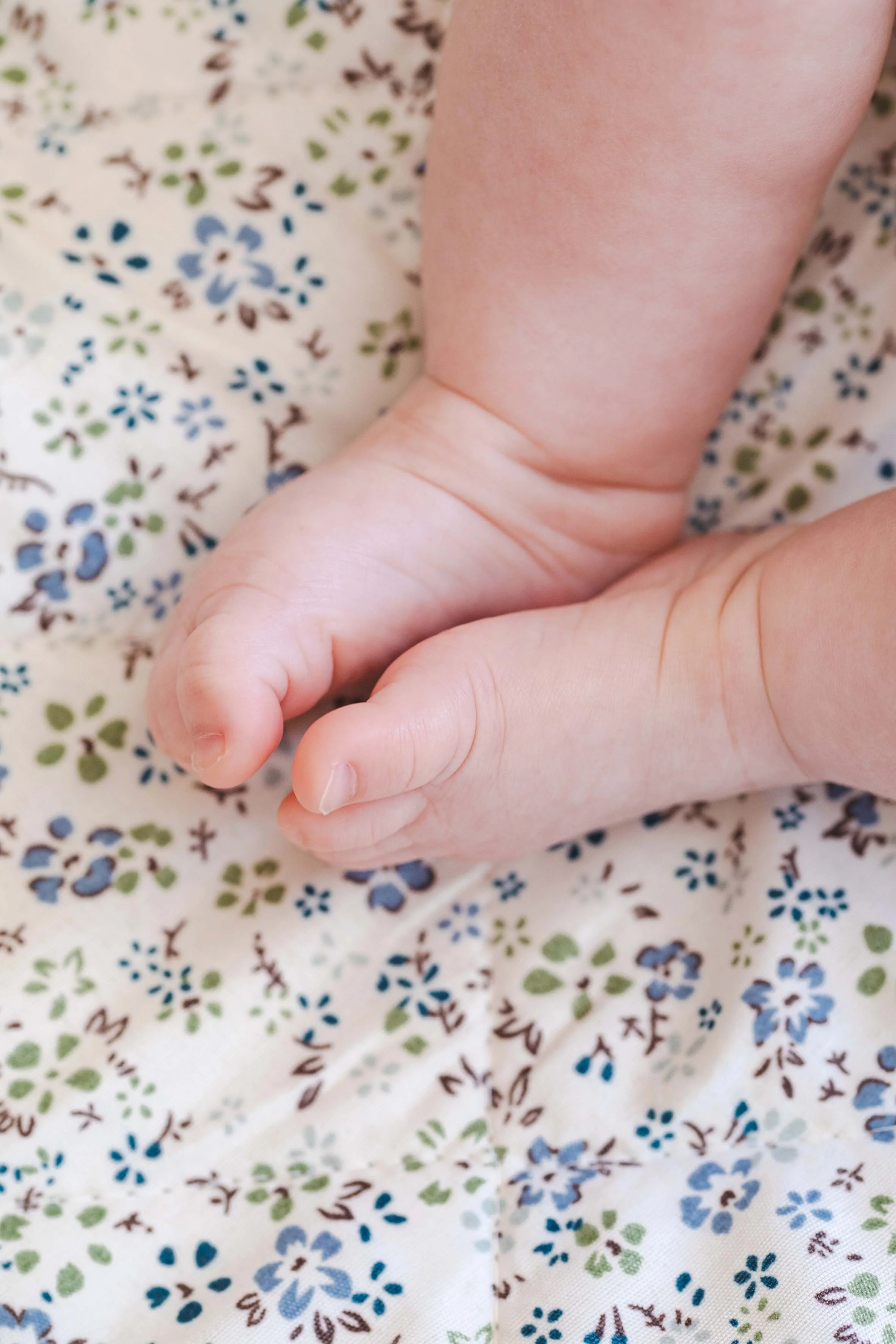cute baby feet in blue sheets