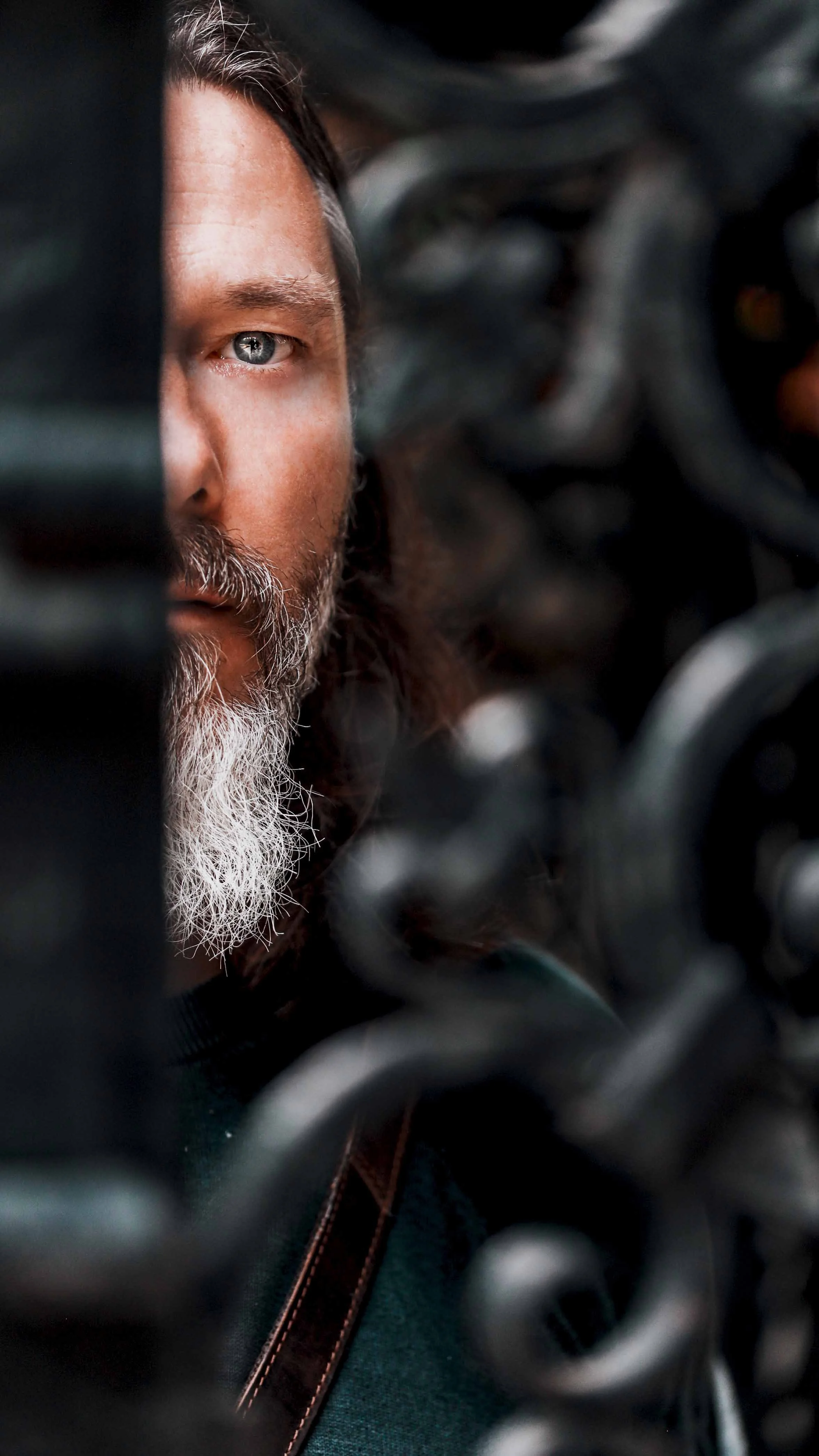 half portrait of a man with blue eyes and beard