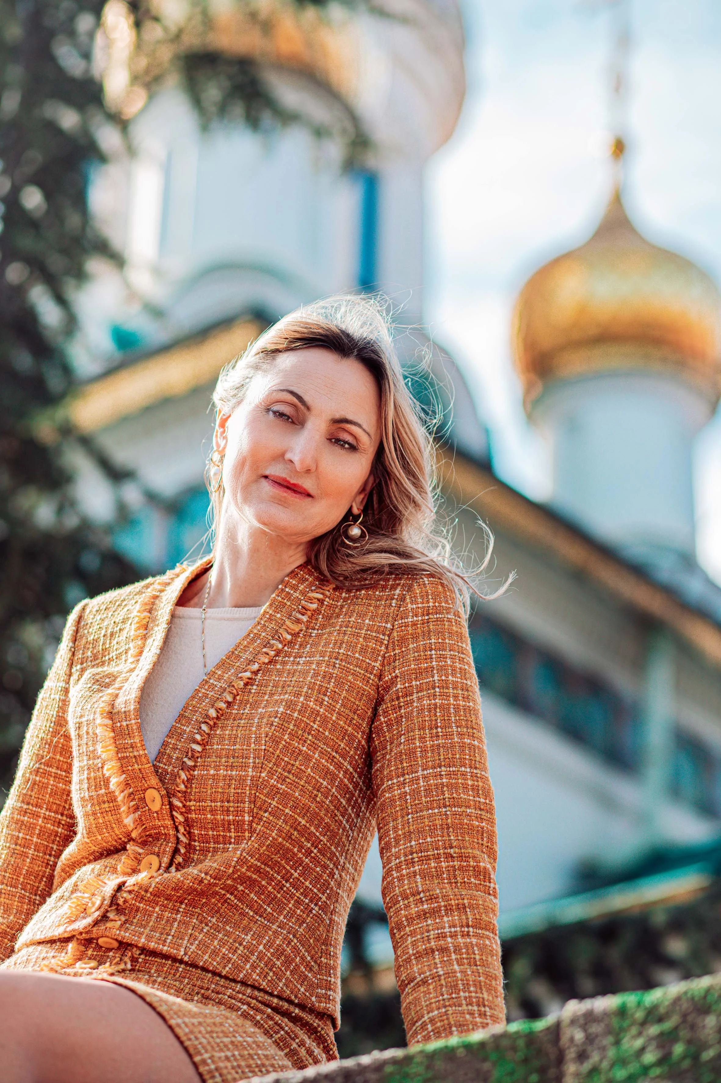 an aristocratic woman dressed in yellow  in front of the church