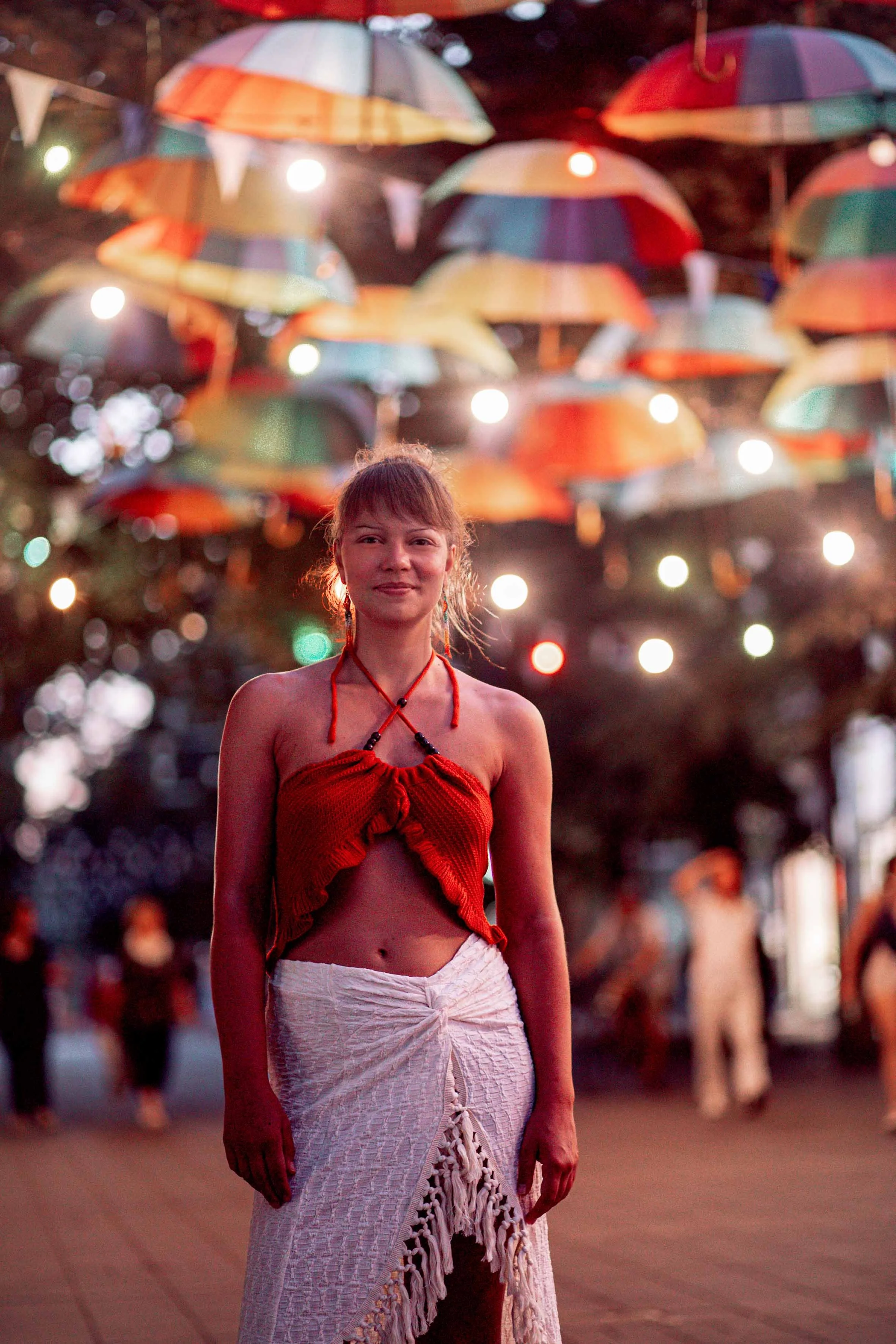 night photography a girl on the street with colourful umbrellas