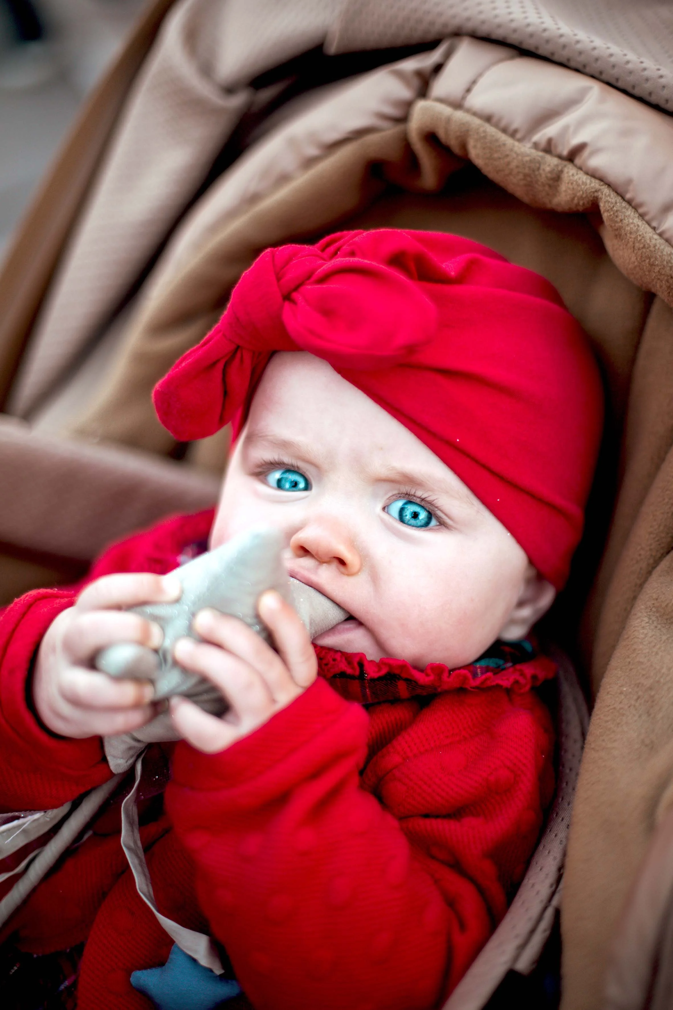 beautiful baby with blue eyes dressed in red