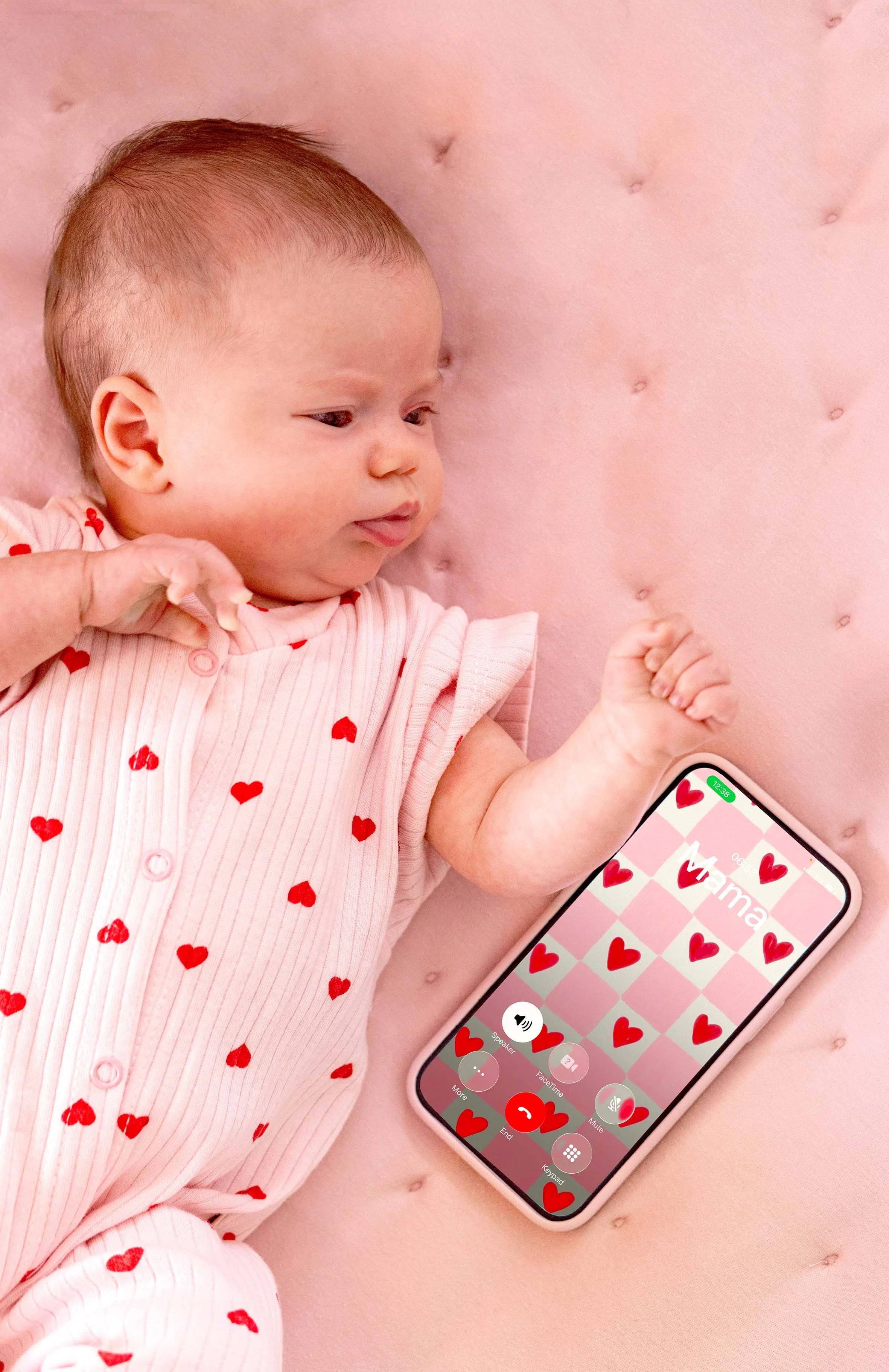 baby in bodysuit with red hearts and mama calling
