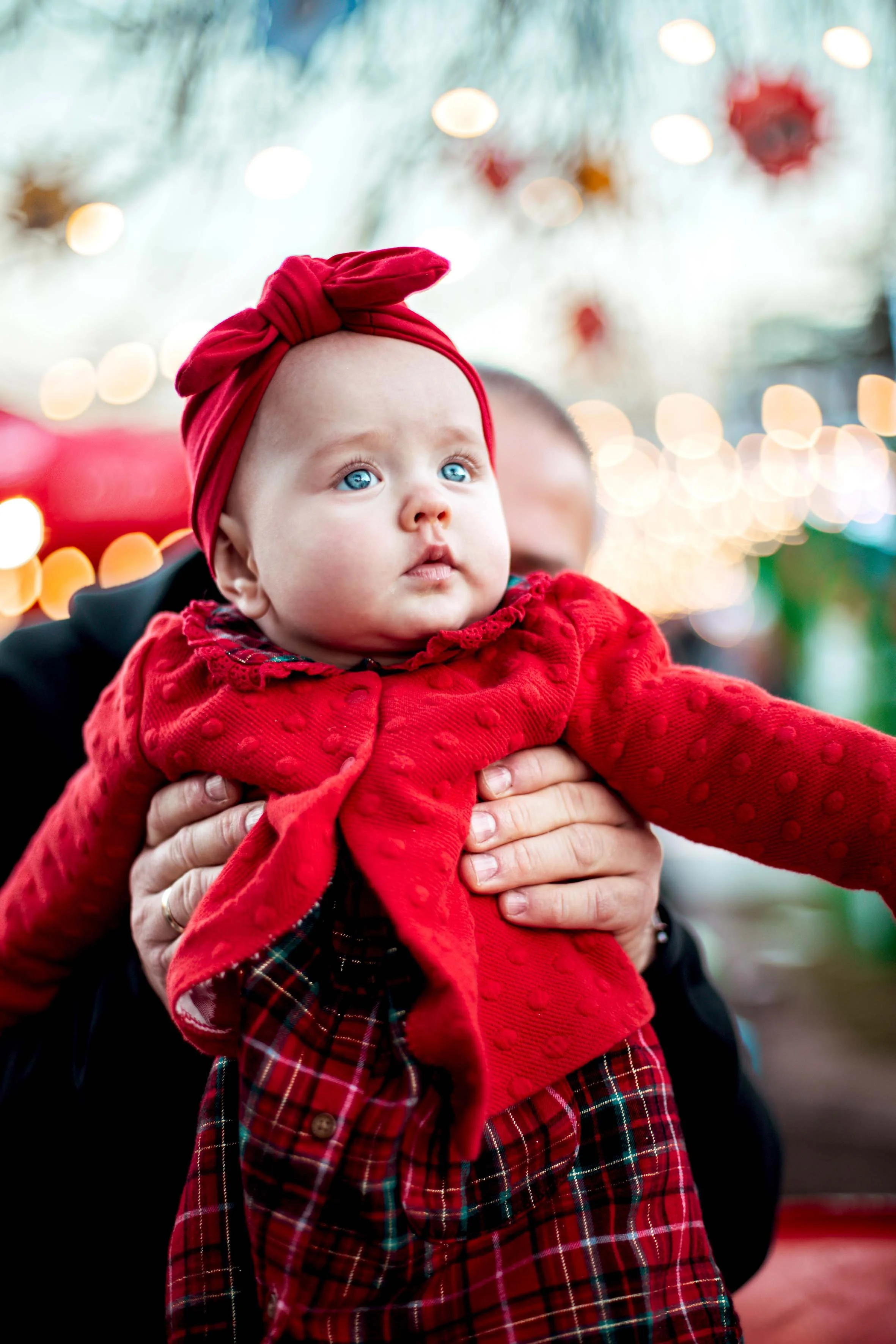beautiful baby with blue eyes dressed in red professional baby photoshoot