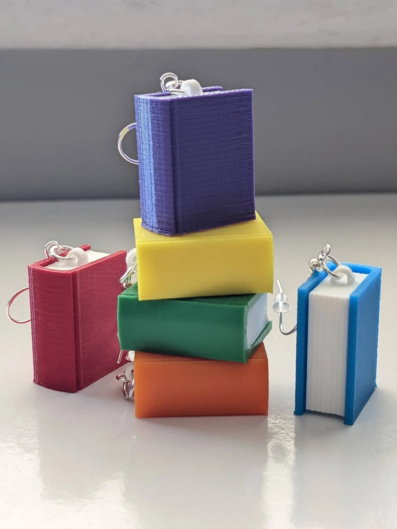 Colorful mini books earrings in purple, yellow, green, orange, red, and blue