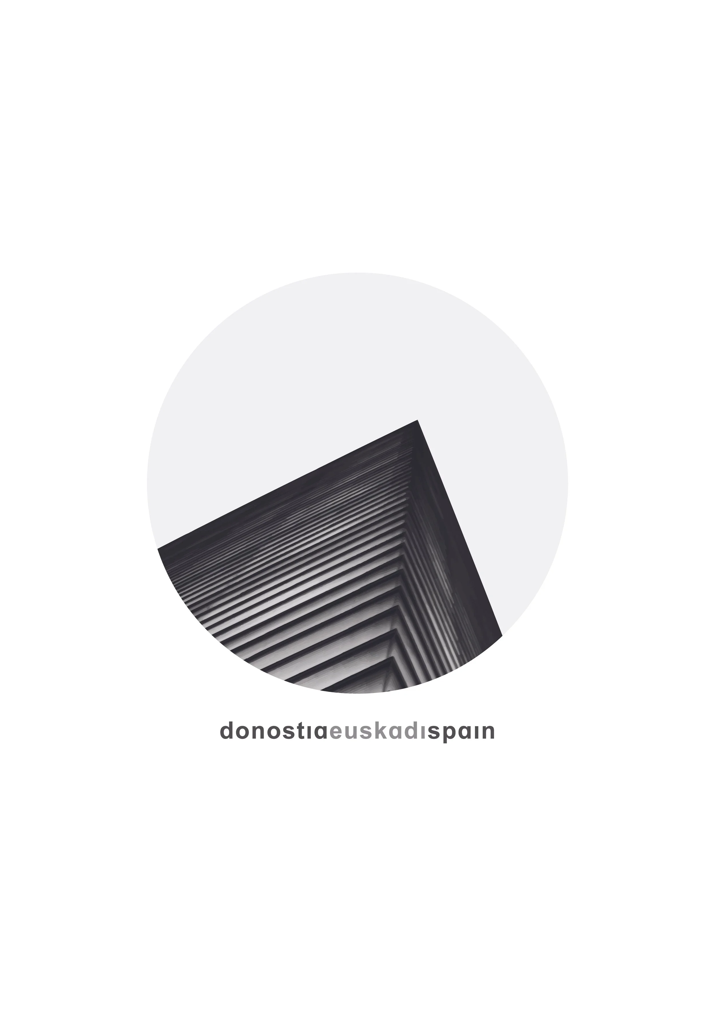 Abstract black and white photograph of a modern building taken from below, with the building's corner in focus. The photo is cropped in a circular shape with the URL 'donostiqueuskadispain' written below.