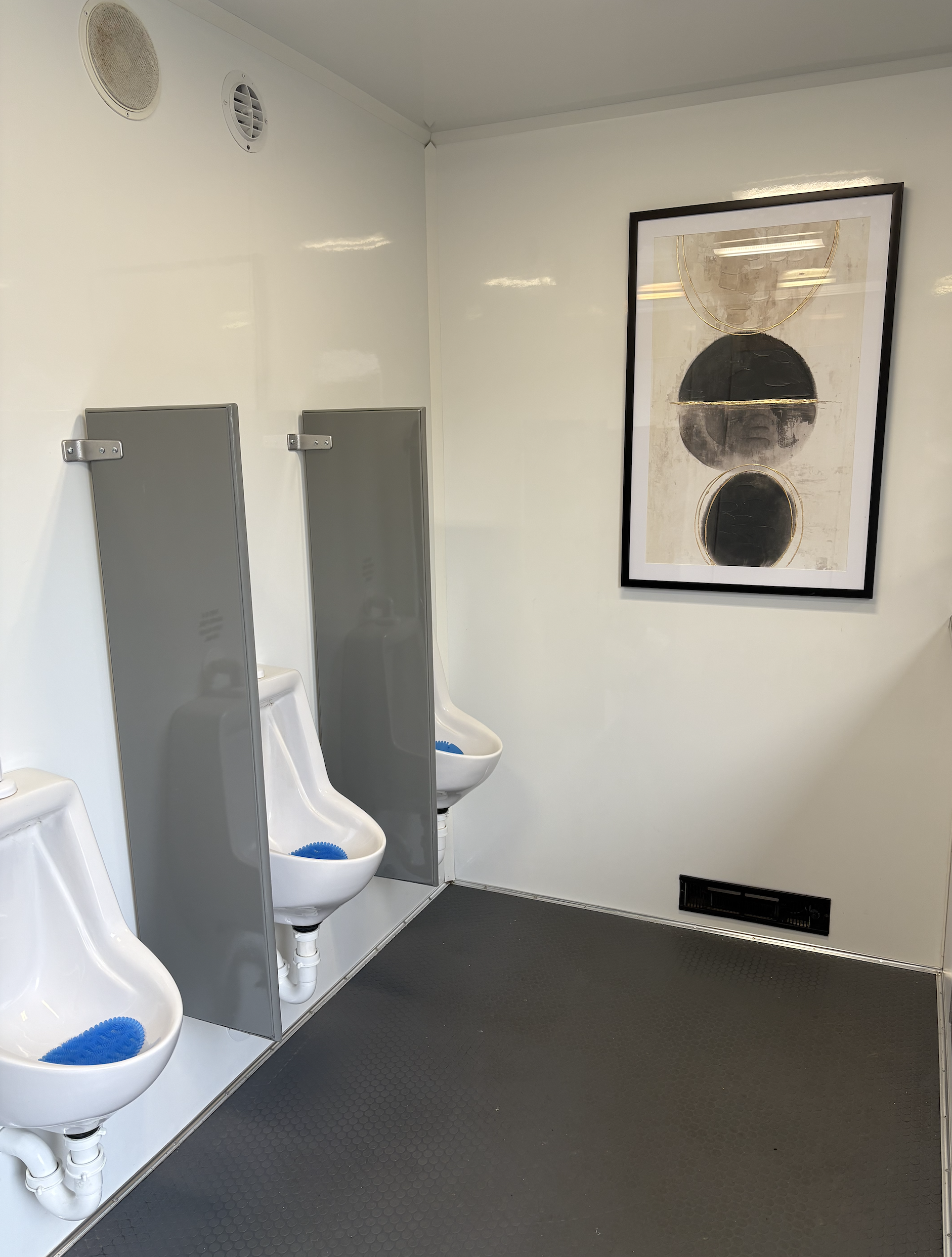 3 urinals in a mobile restroom trailer.