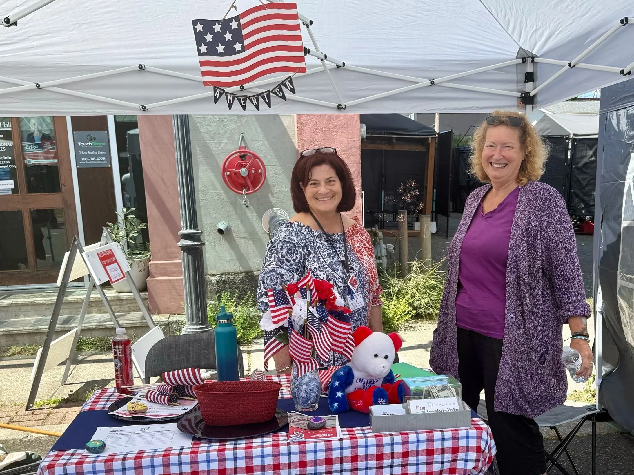Just two of the many intrepid volunteers staffing our Indivisible 4th Corner information table!
