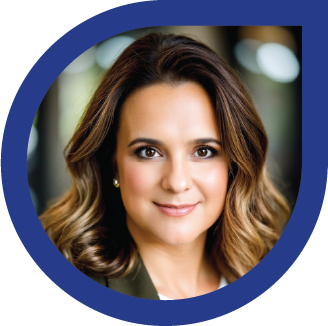 Close-up portrait of a woman with brown hair and a slight smile, wearing a dark top.