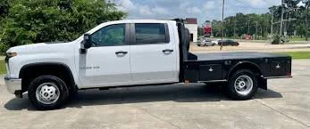 White and black flatbed truck parked outdoors
