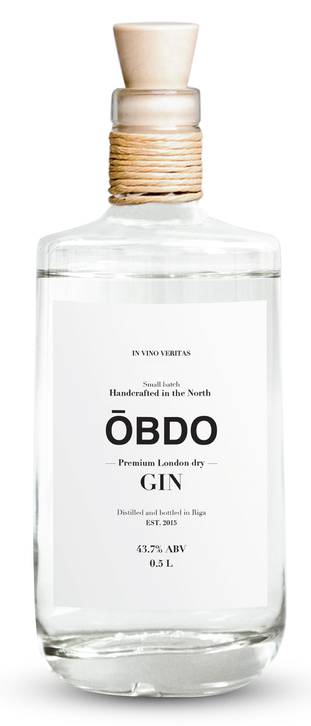 A clear glass bottle with a wooden stopper, labeled as premium London dry gin, with a minimalist white label indicating it's handcrafted in the North, distilled in Riga, with 43.7% ABV and 0.5 liters.