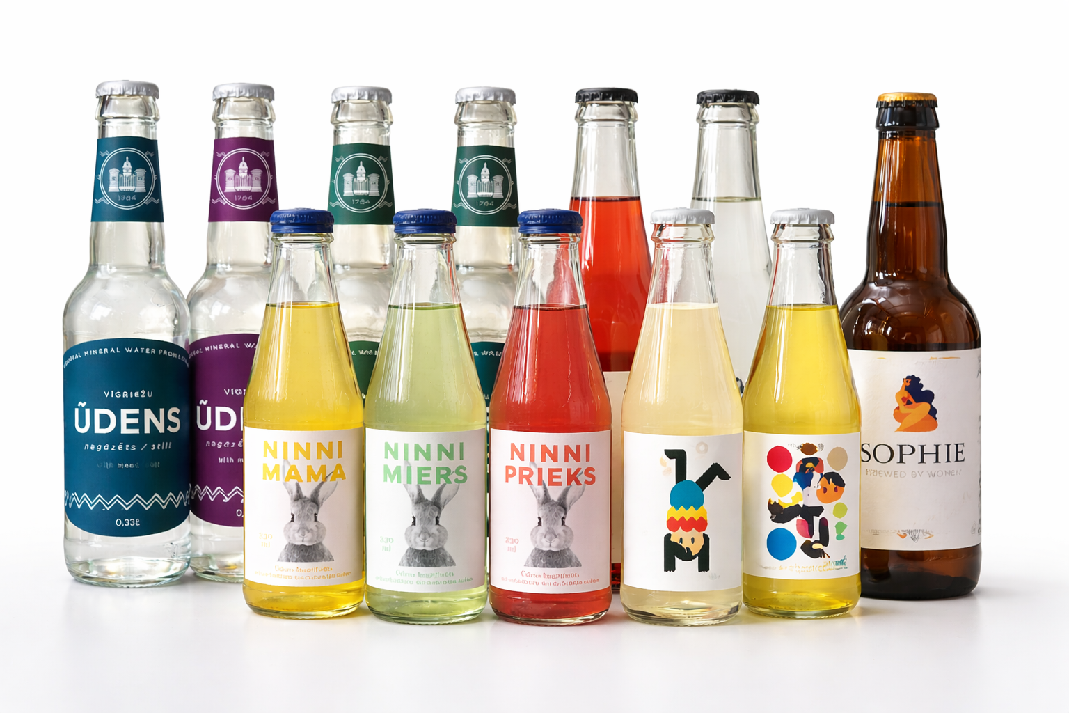 Collection of glass bottles containing colorful beverages with various labels and caps, some featuring cartoon animals, abstract art, and text.