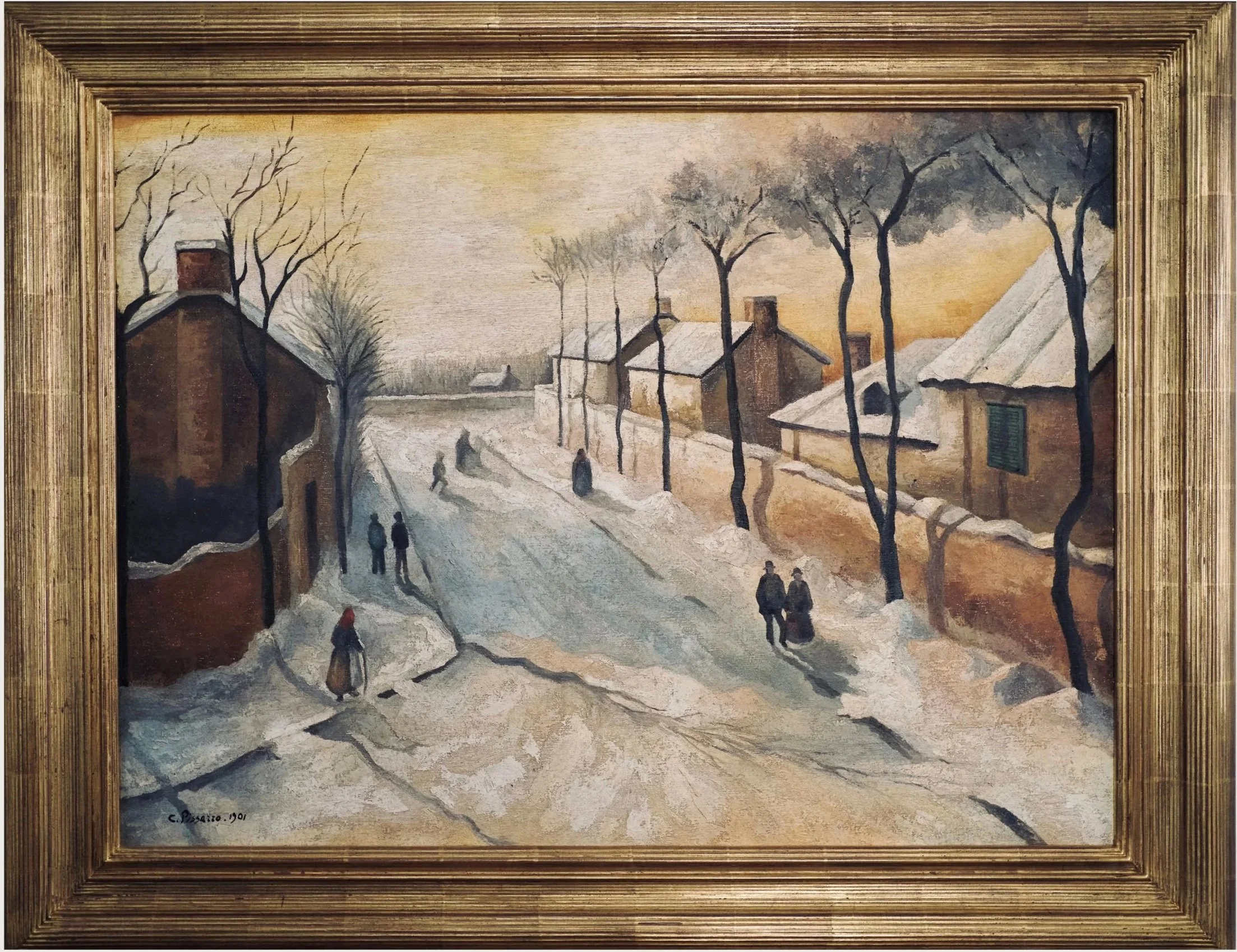 A framed landscape painting depicting a winter village scene with snow-covered houses, leafless trees, and people walking on a snow-covered street during sunset or sunrise.