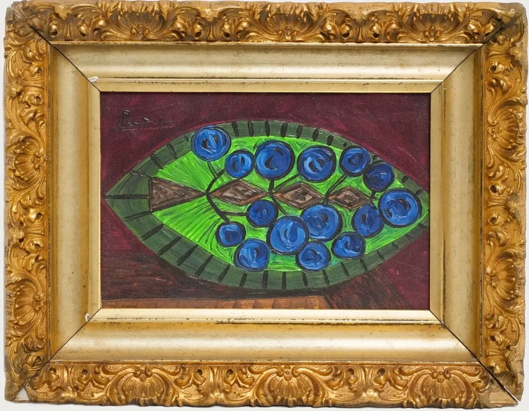Painted artwork of a cluster of grapes inside a green oval-shaped dish, surrounded by a dark red backdrop, framed by an ornate gold decorative frame.