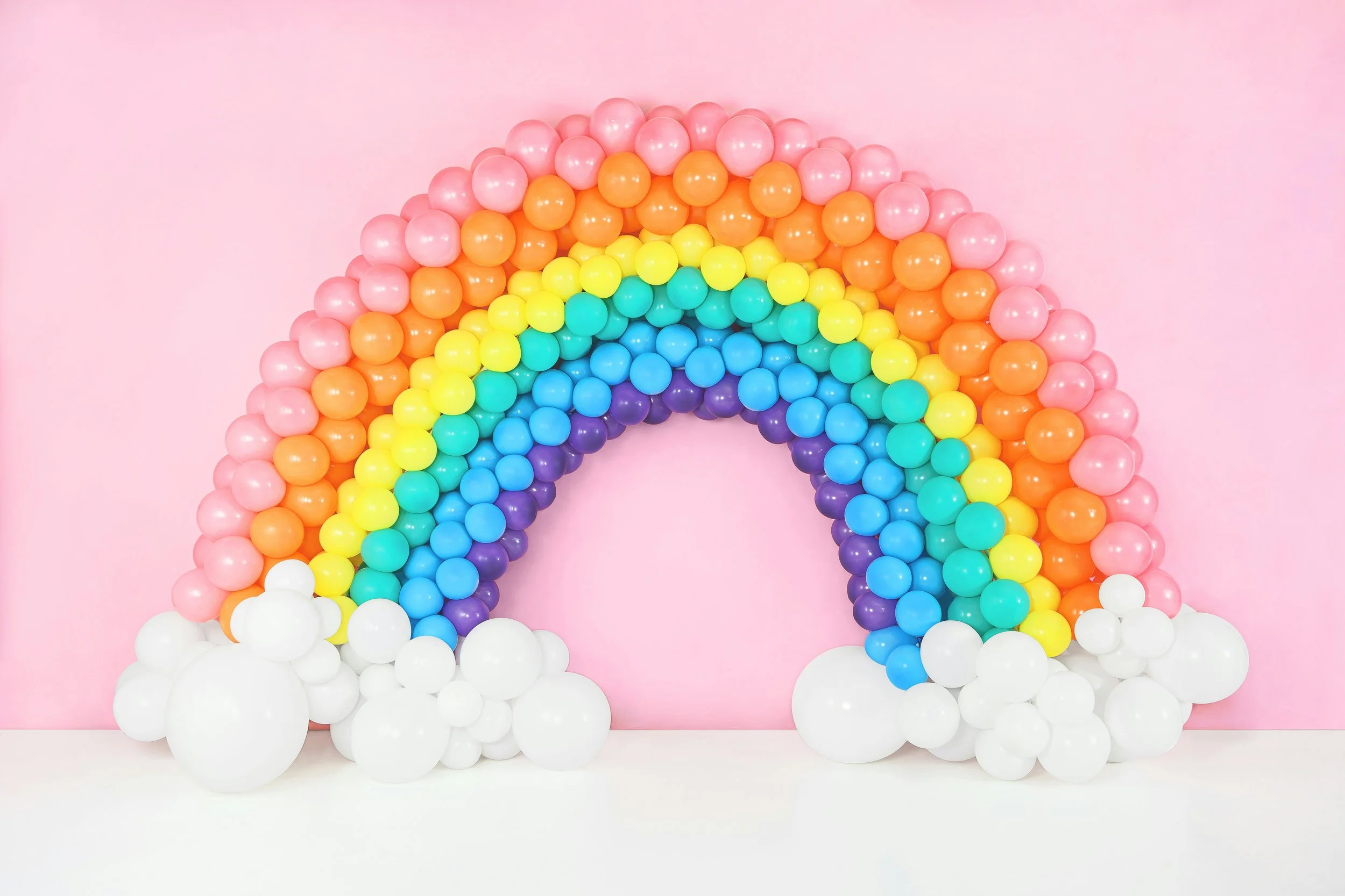Rainbow balloon arch with clouds on the end