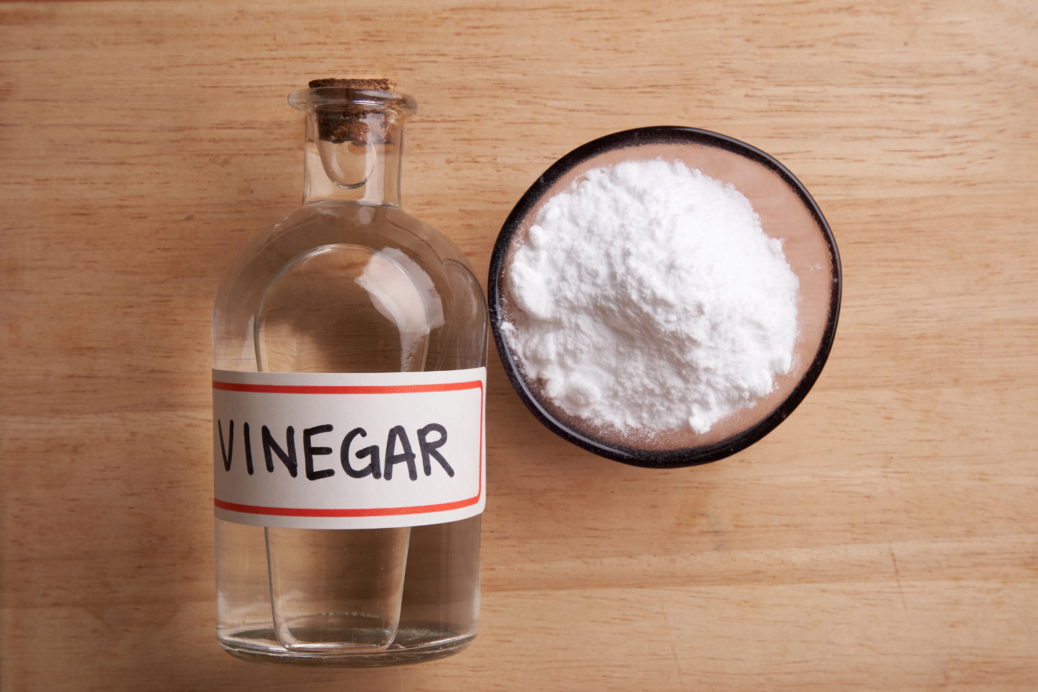vinegar bottle with baking soda in bowl