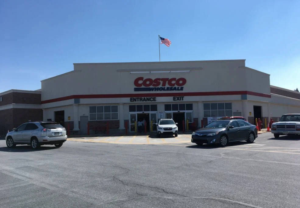 Entrance in front of Costco with cars in parking lot