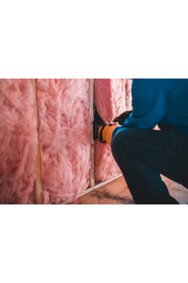 Man insulating attic saves heat