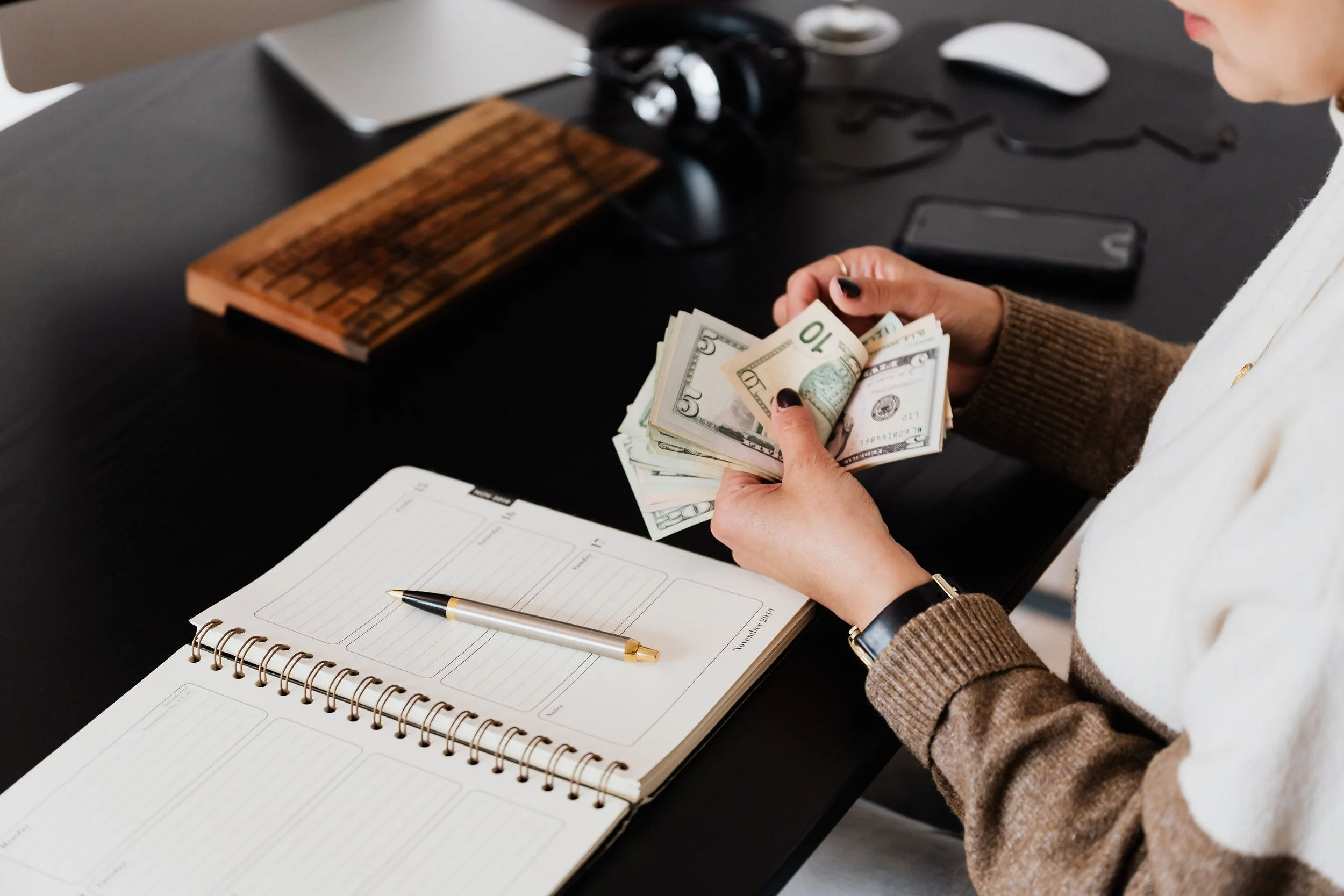 Women counting money by computer