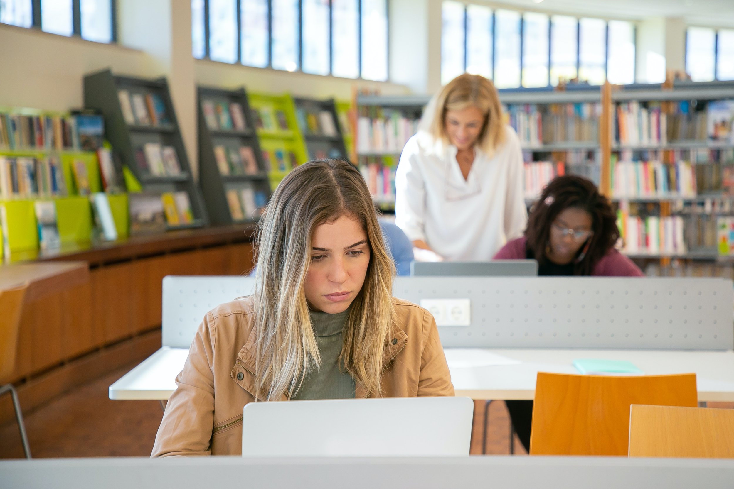 student in library on laptop