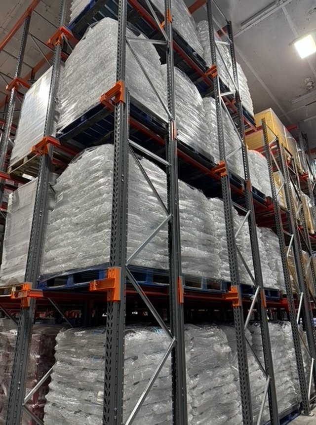 Large steel warehouse shelving holding multiple pallets of Jam Inns Ice wrapped & ready to head off to Glastonbury Festival for ice supply to major festivals & events in the South West & South Wales.